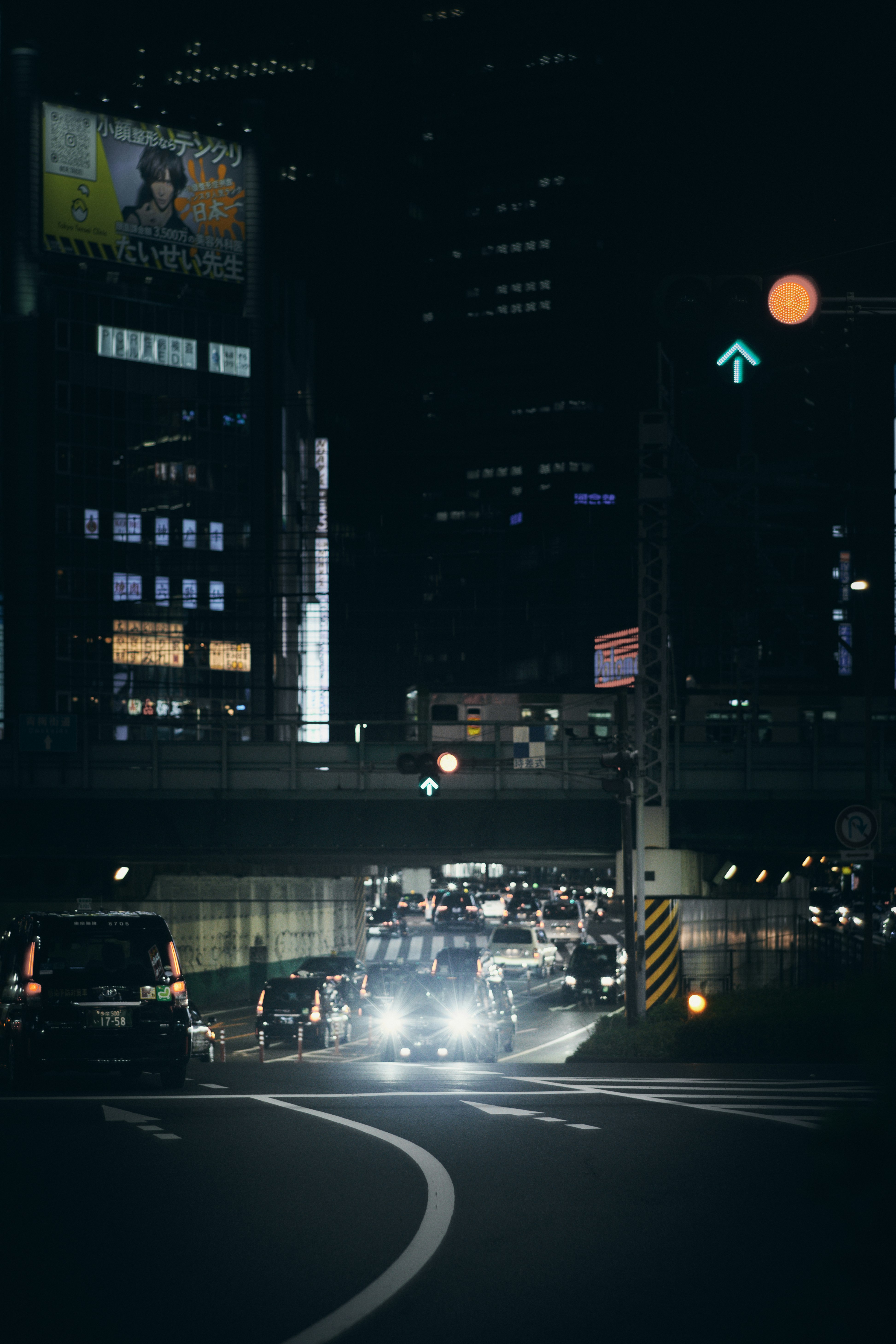night intersection with car headlights in a downtown business district
