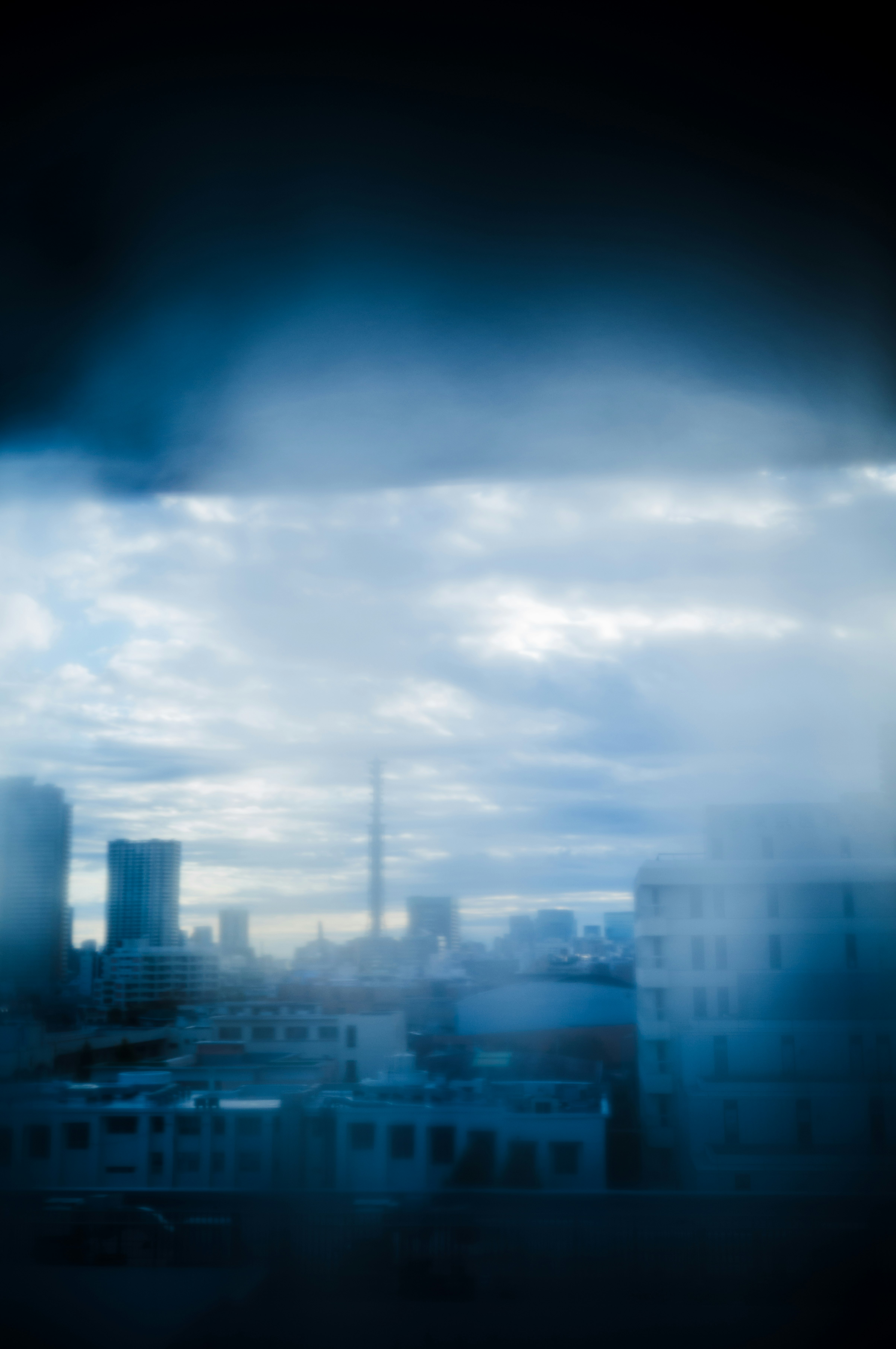 Urban landscape with cloudy sky and mist
