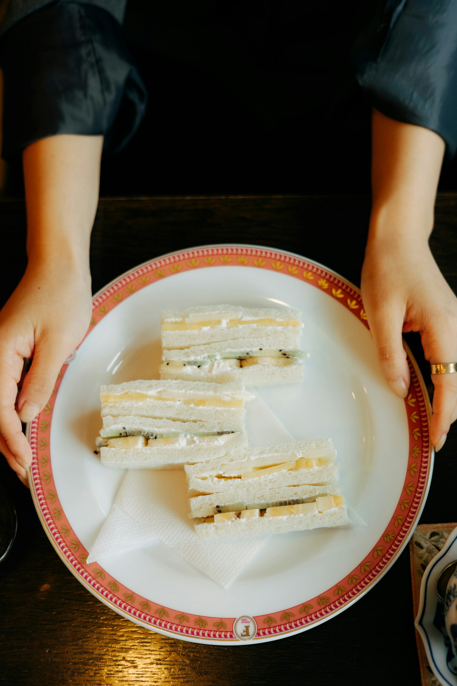 Fette di dessert su un piatto bianco tenute da mani