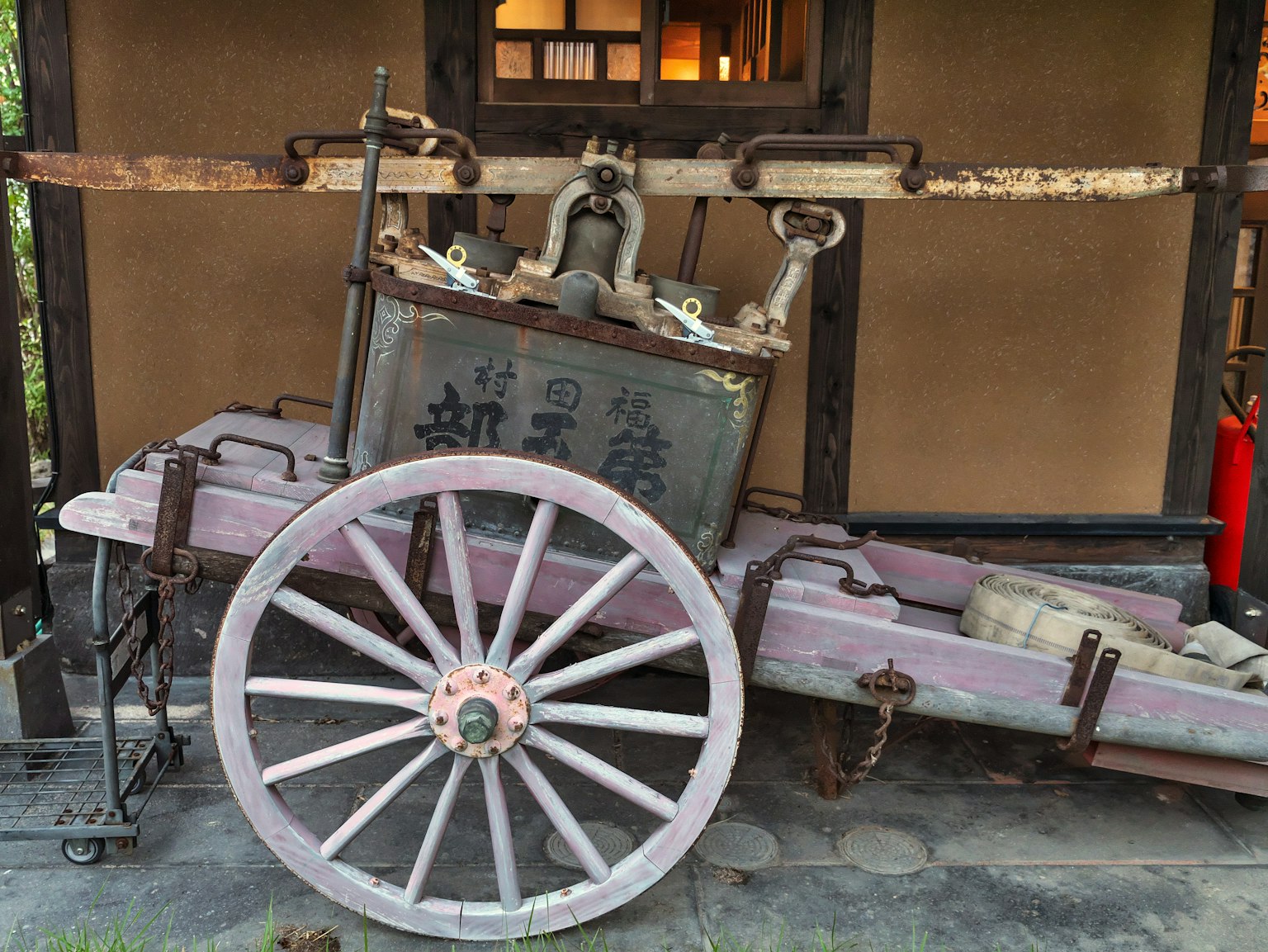 An old wooden cart placed against a traditional background