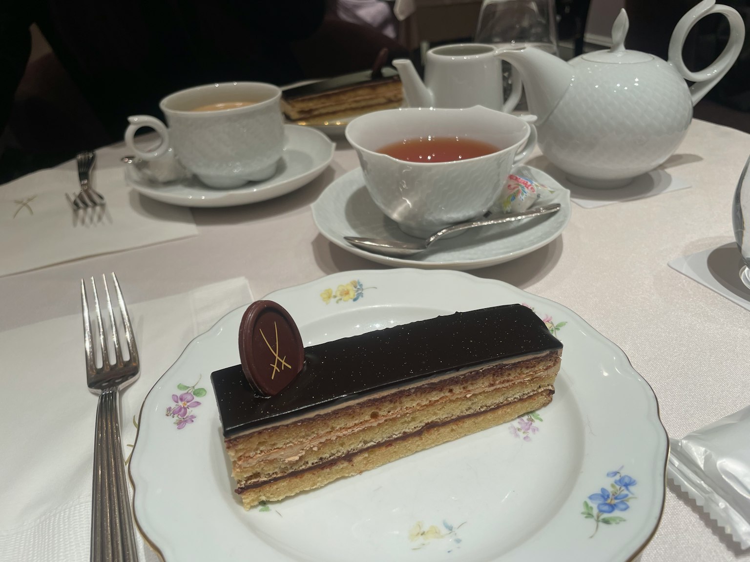 Tea and cake table setting with a modern dessert on a plate