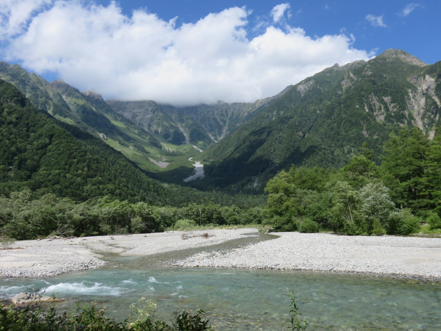 ทิวทัศน์ที่สวยงามของภูเขาและท้องฟ้าสีฟ้าพร้อมกับแม่น้ำที่ไหล