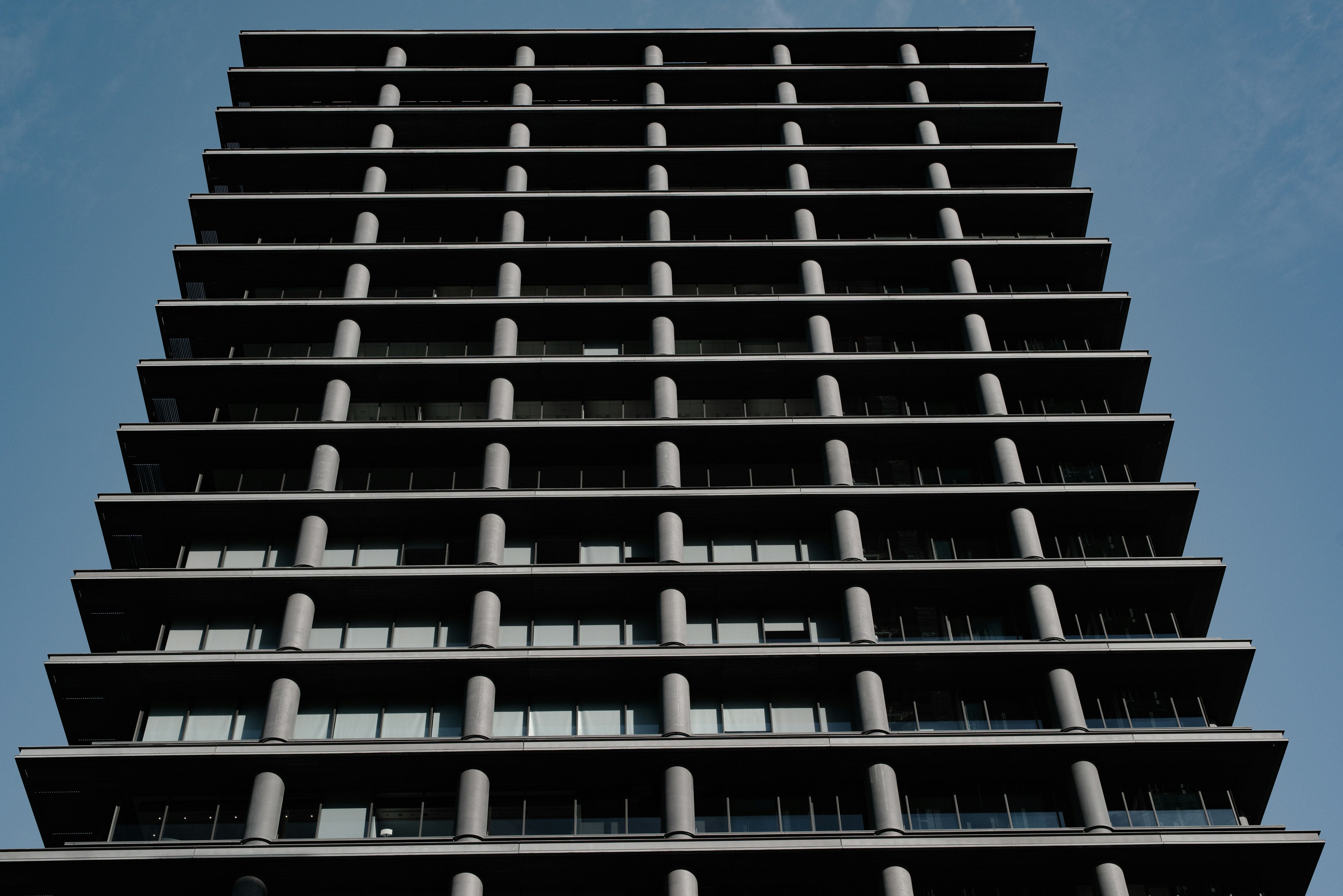 Geometric facade with rows of cylindrical columns on a modern building