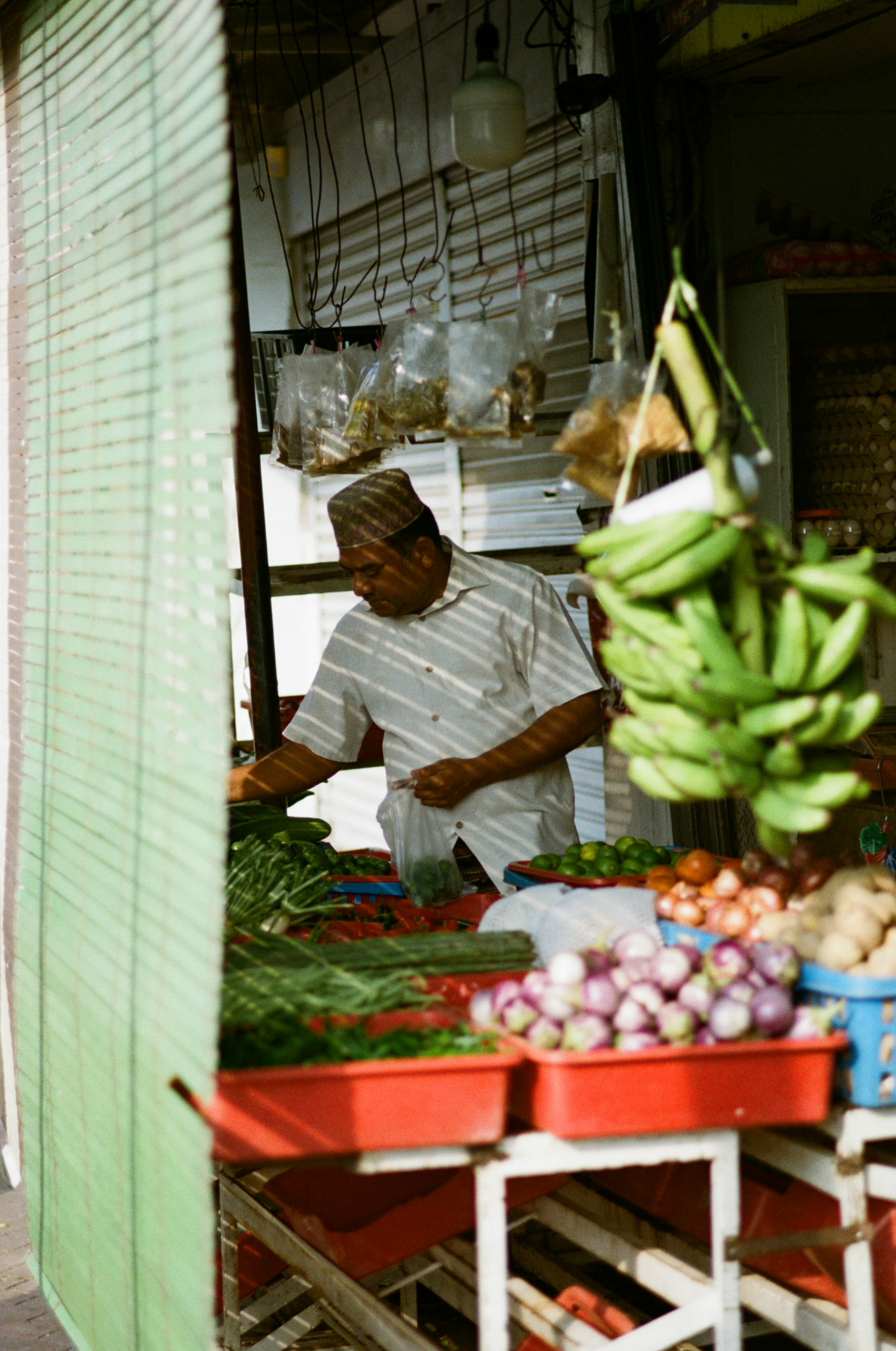 fruit and vegetable stall at a narrow street market