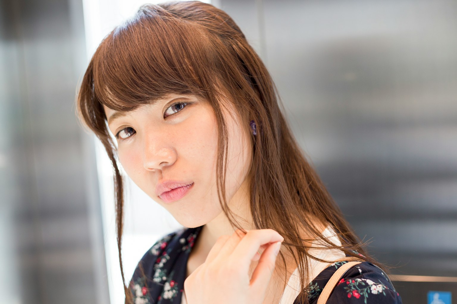 电梯内女性的肖像 自然光照亮她的脸庞 露出微笑