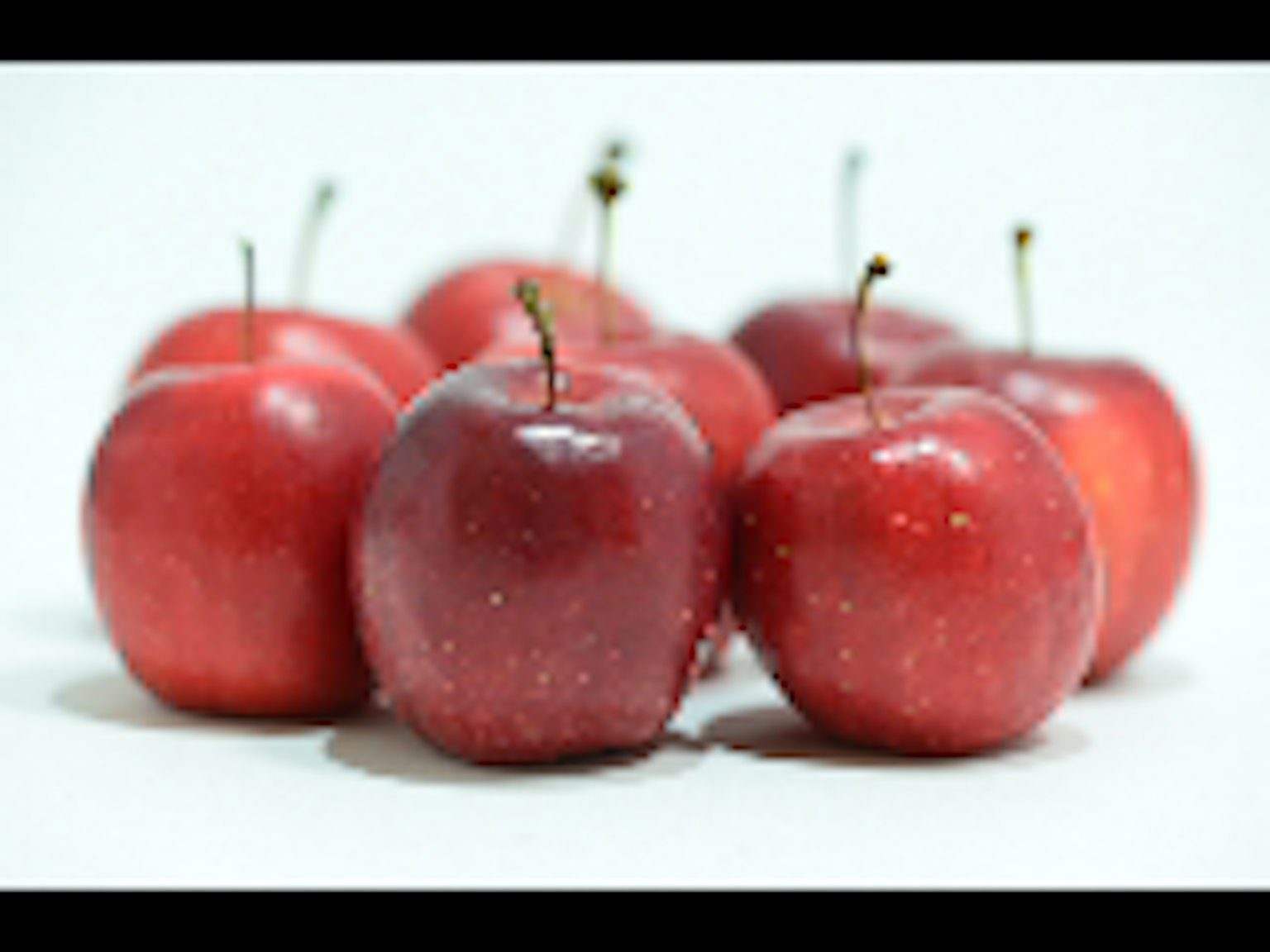 A cluster of red apples on a white background