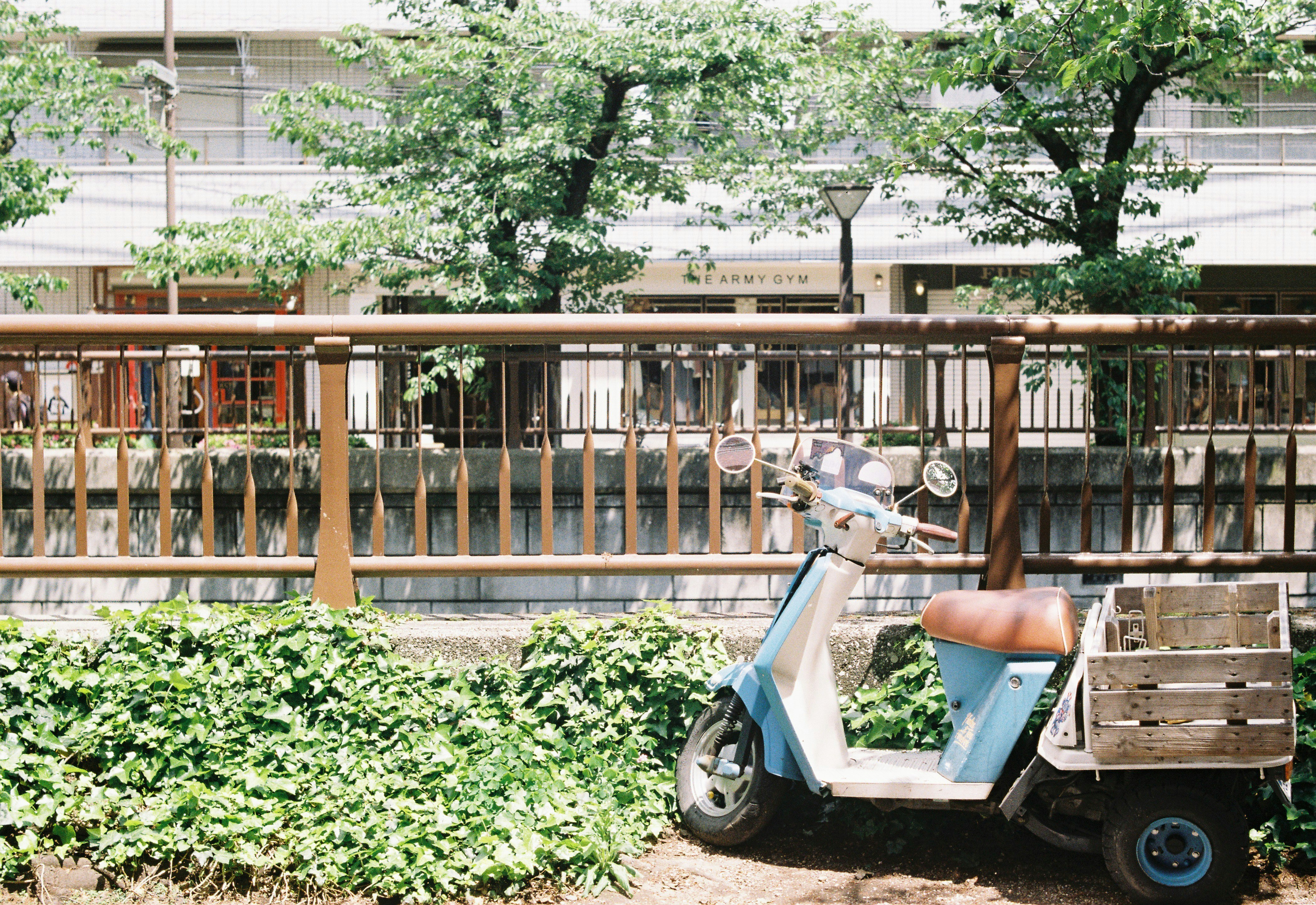 electric three-wheeled cart parked in a courtyard with trees