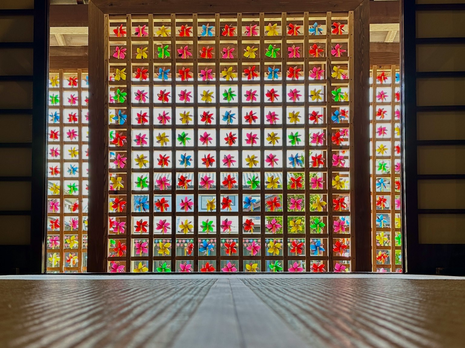 Colorful glass window featuring traditional Japanese architecture indoors