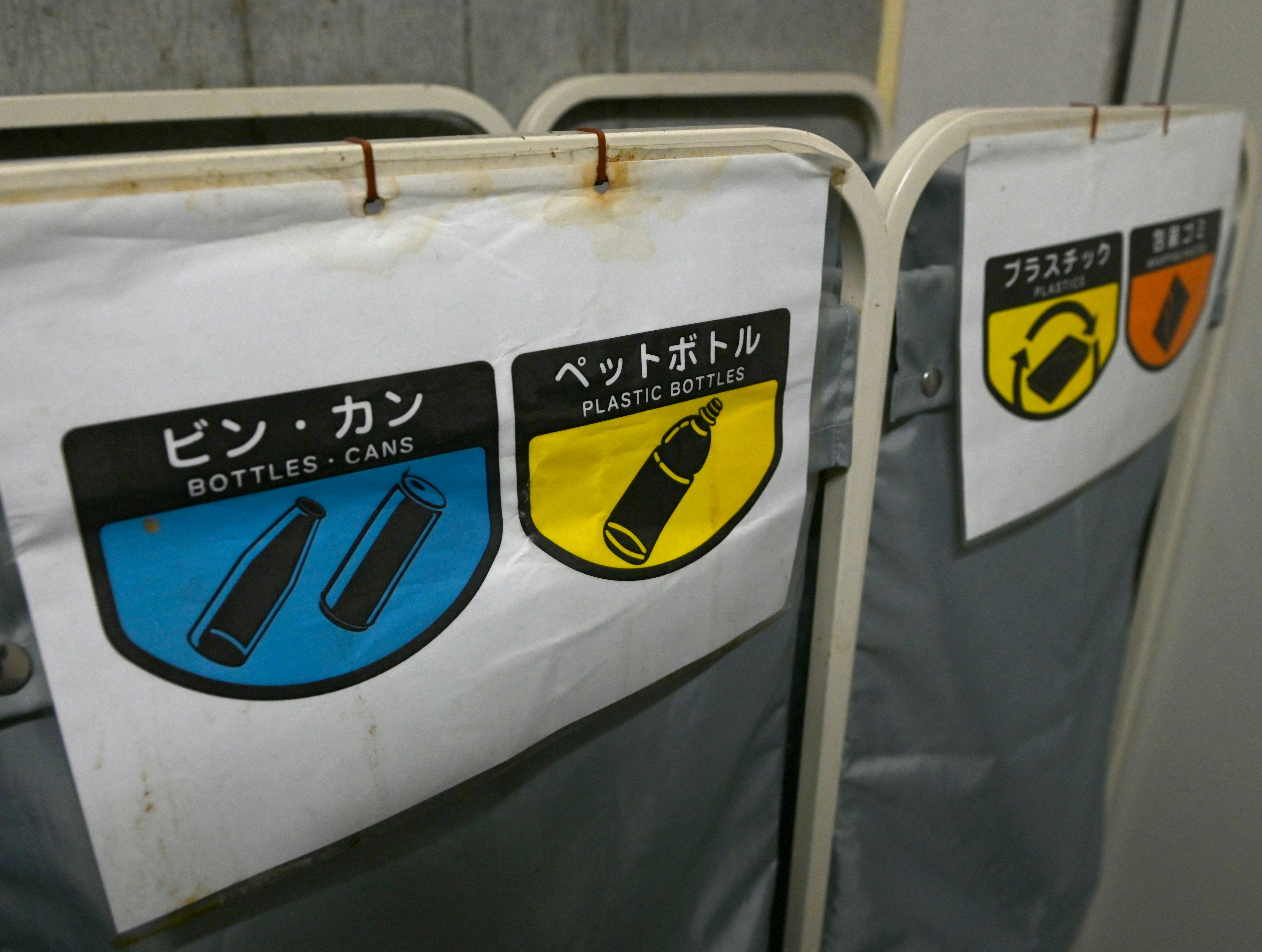 Close-up of labeled plastic bottle containers on a vending-style unit