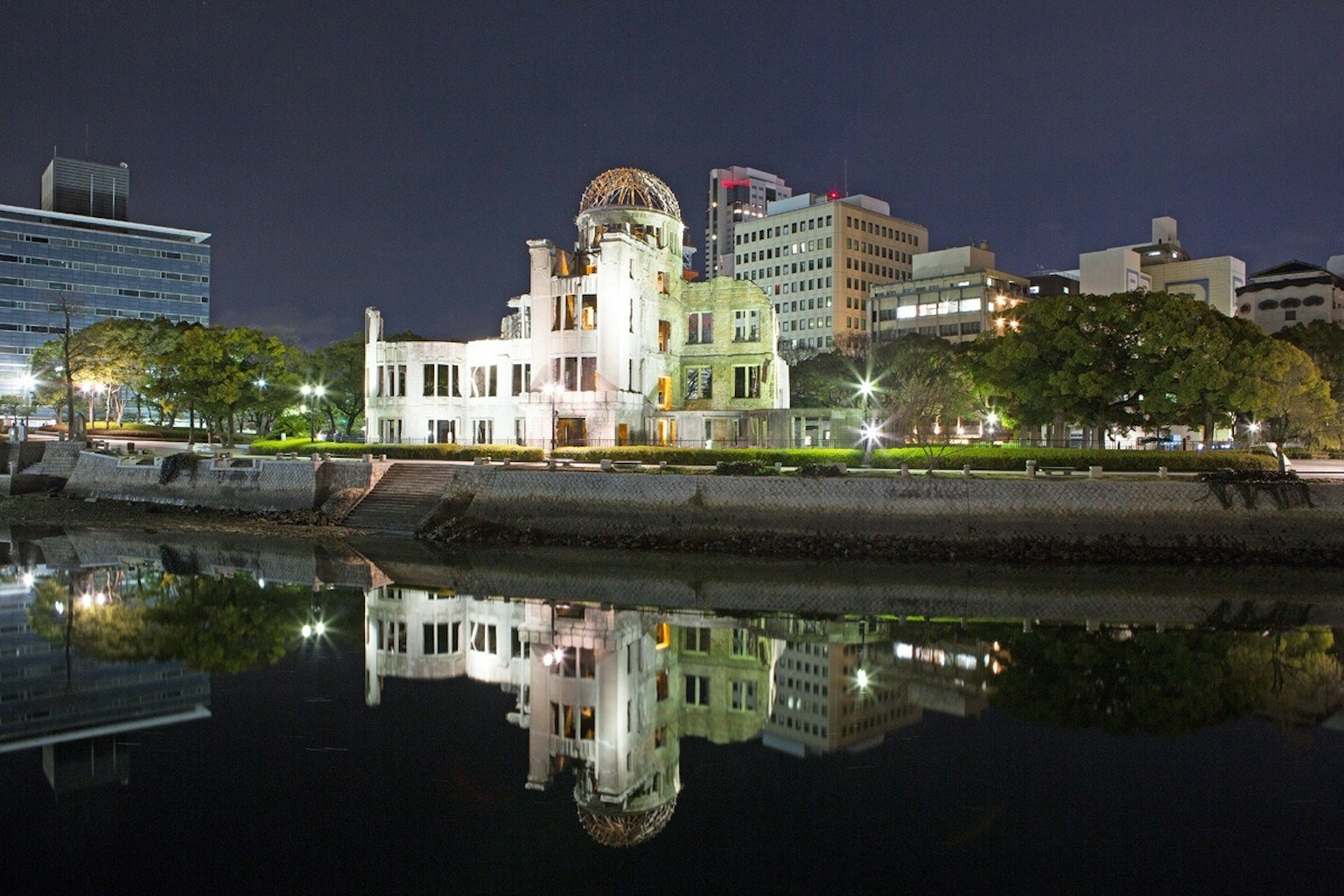 Night view of Hiroshima Peace Memorial Museum with reflection in the water