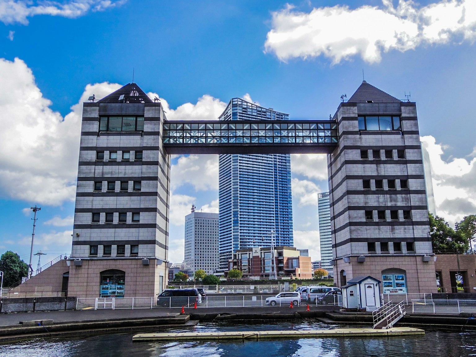 Modern buildings along a river with a high-rise in the background