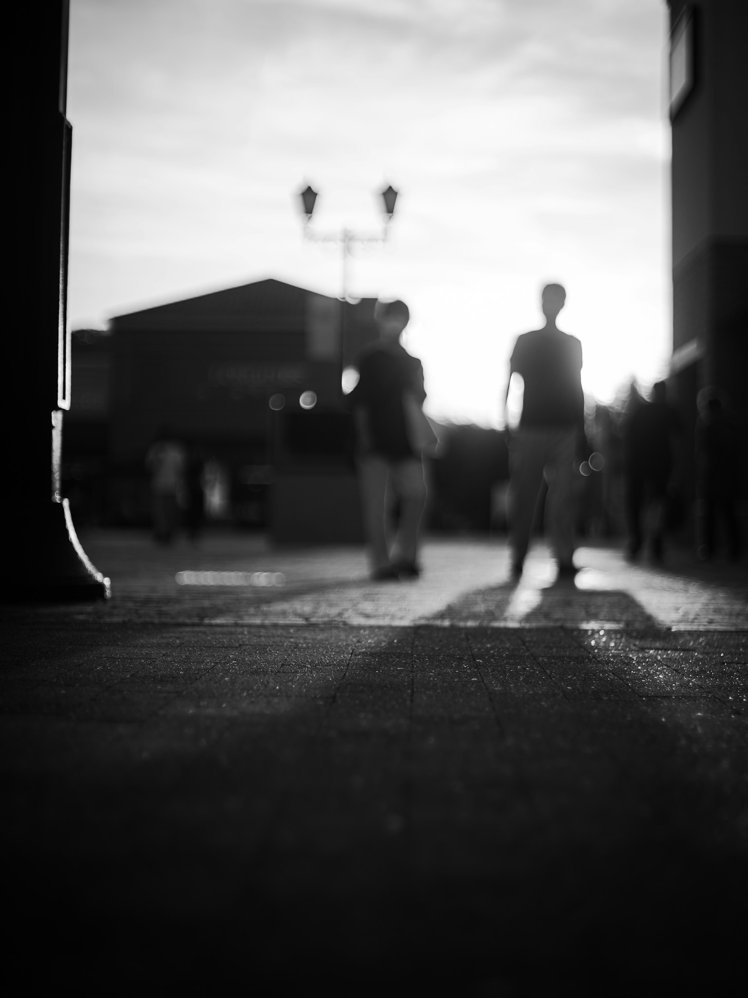 Black and white street scene with people walking