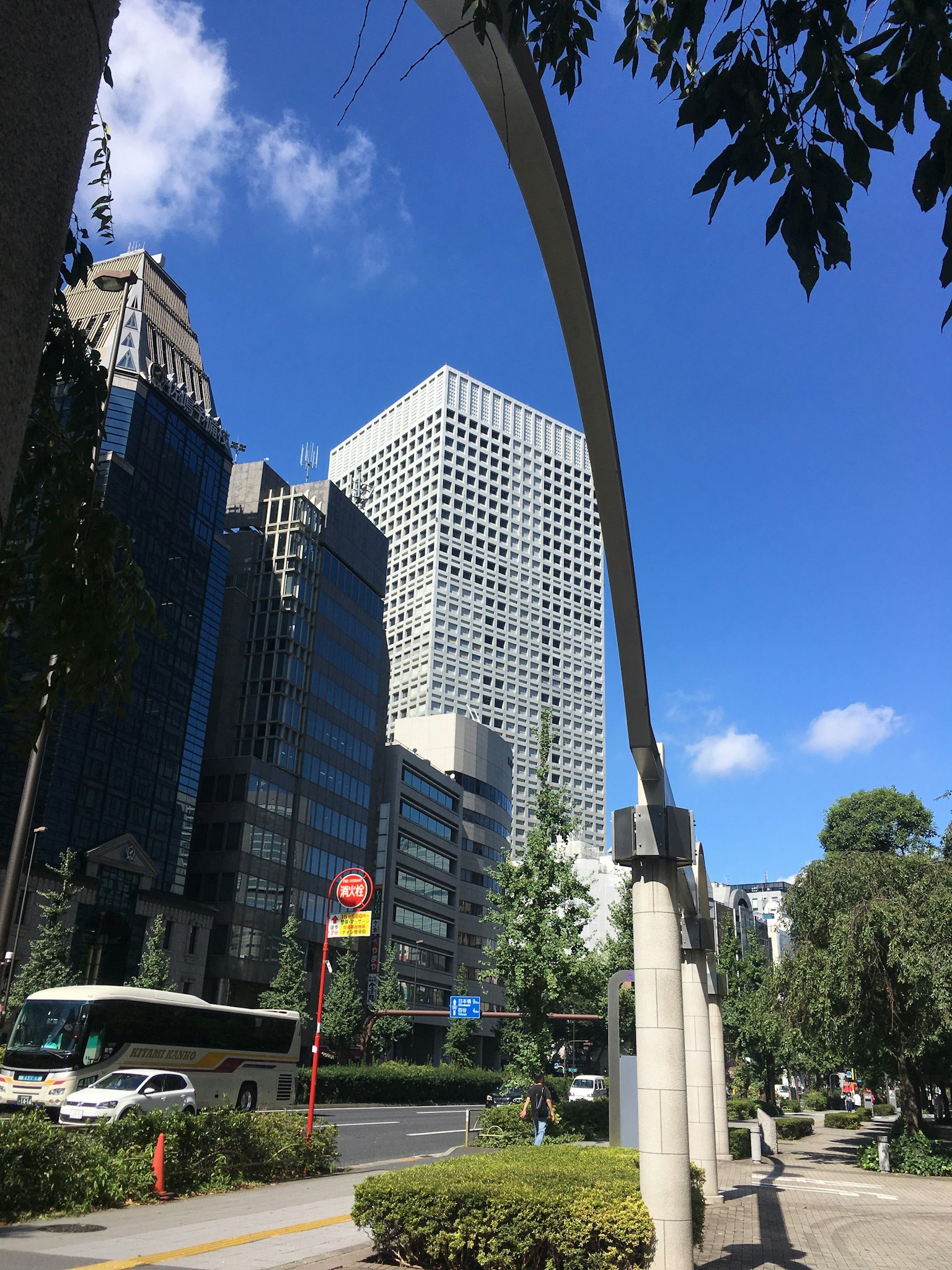 View of skyscrapers under a clear blue sky with an arch structure in the foreground