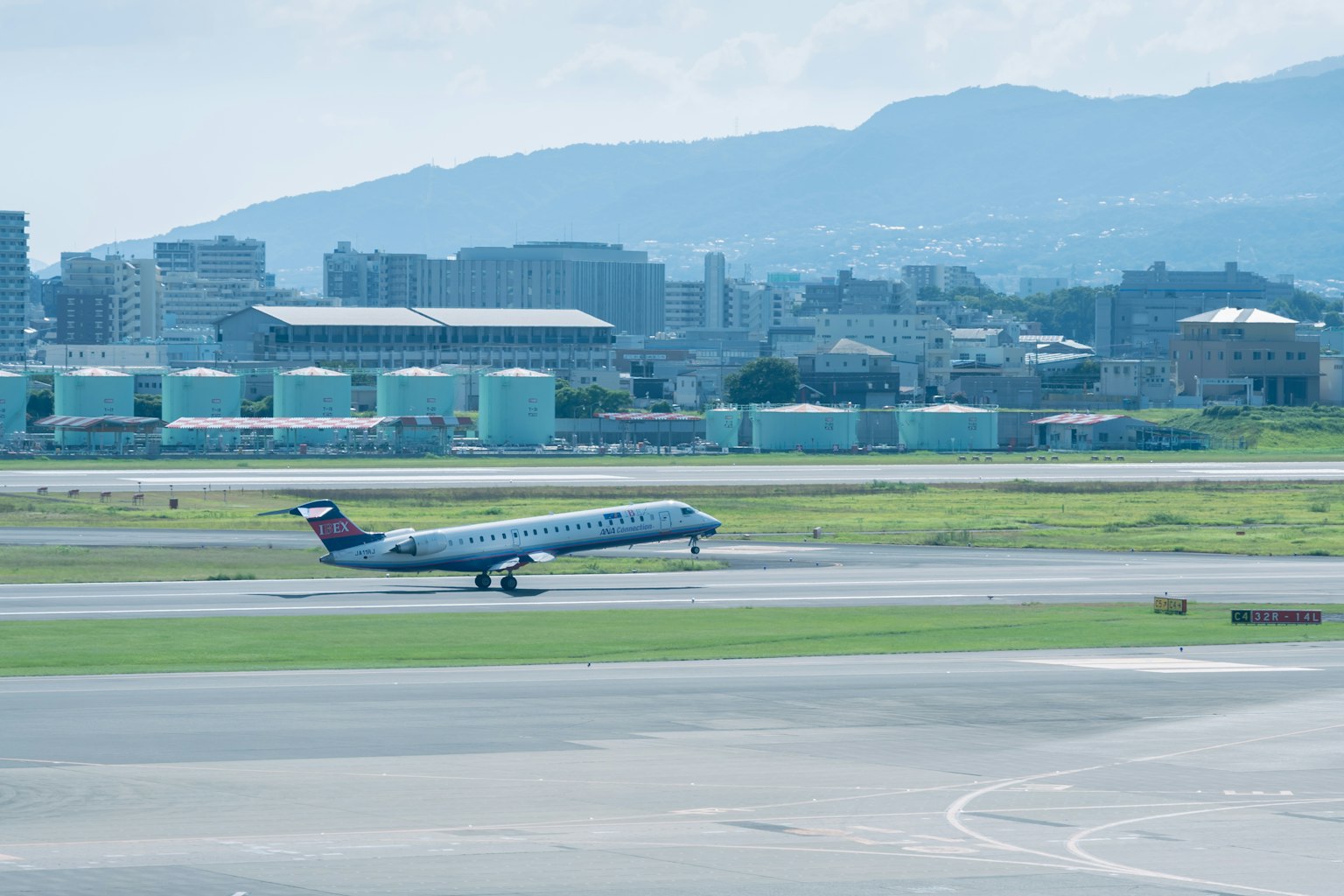 Passenger airplane taking off at the airport with mountains in the background