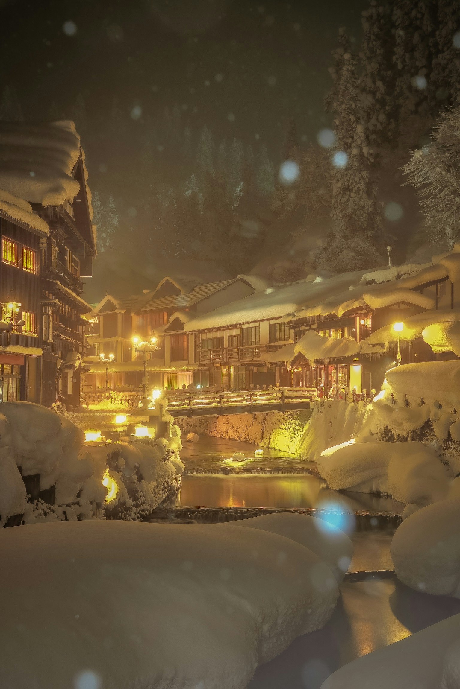 雪覆盖的温泉镇夜景温暖的灯光