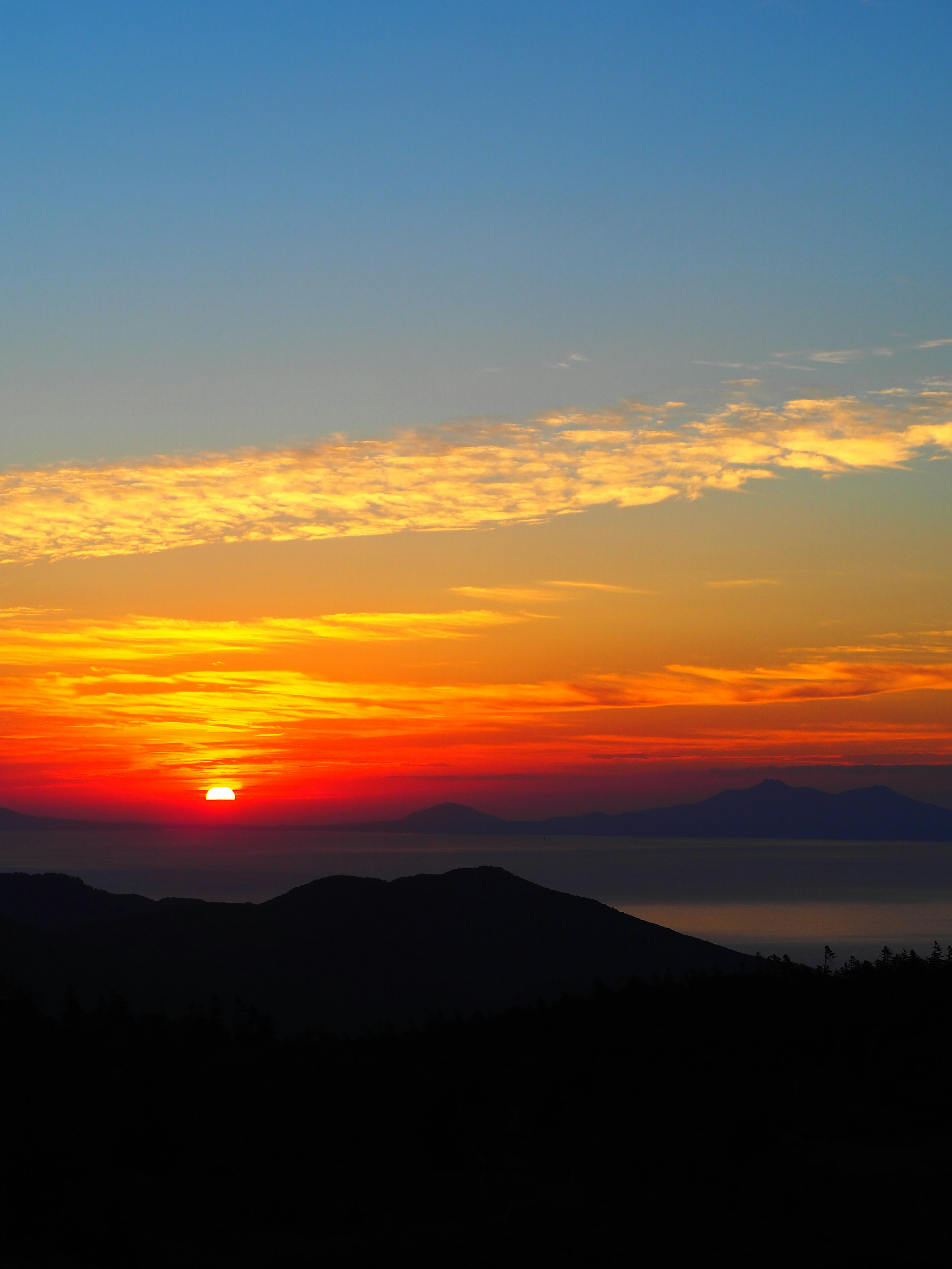 sunset sky over mountain silhouettes