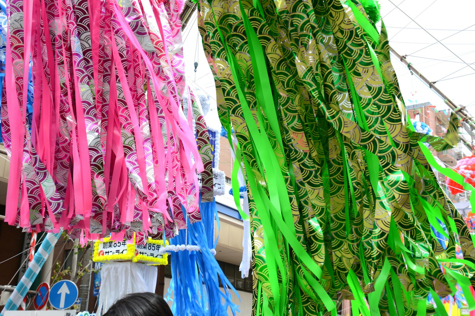 Colorful ribbons hanging in an outdoor market scene