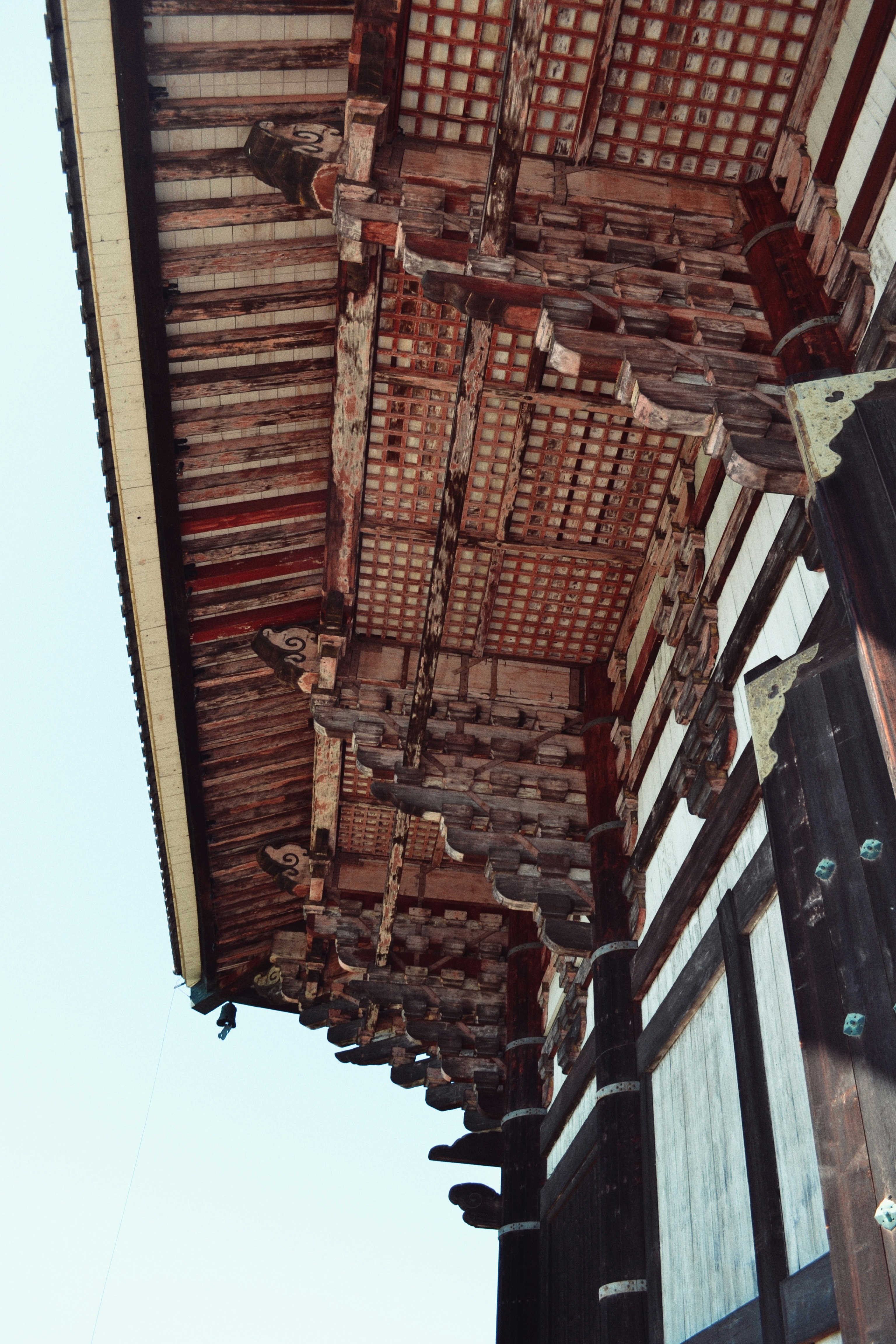 overhang of an old building with lattice ceiling and beams