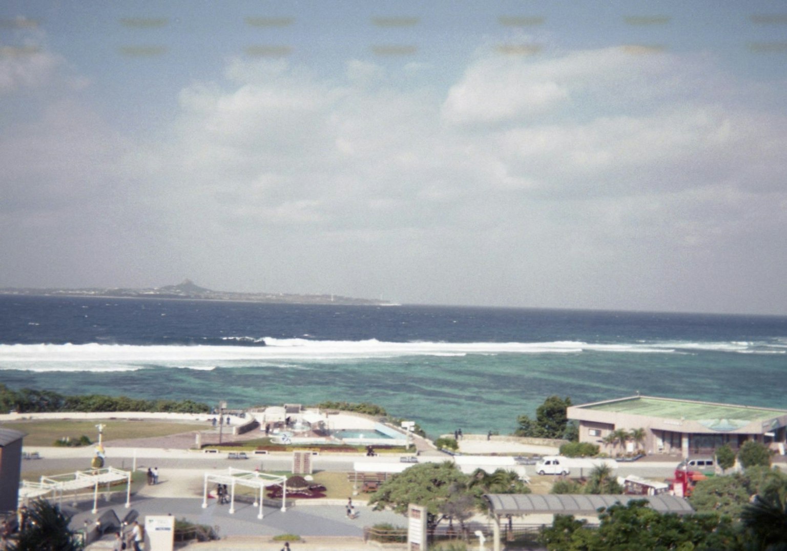 Scenic view of blue ocean with white waves and beach