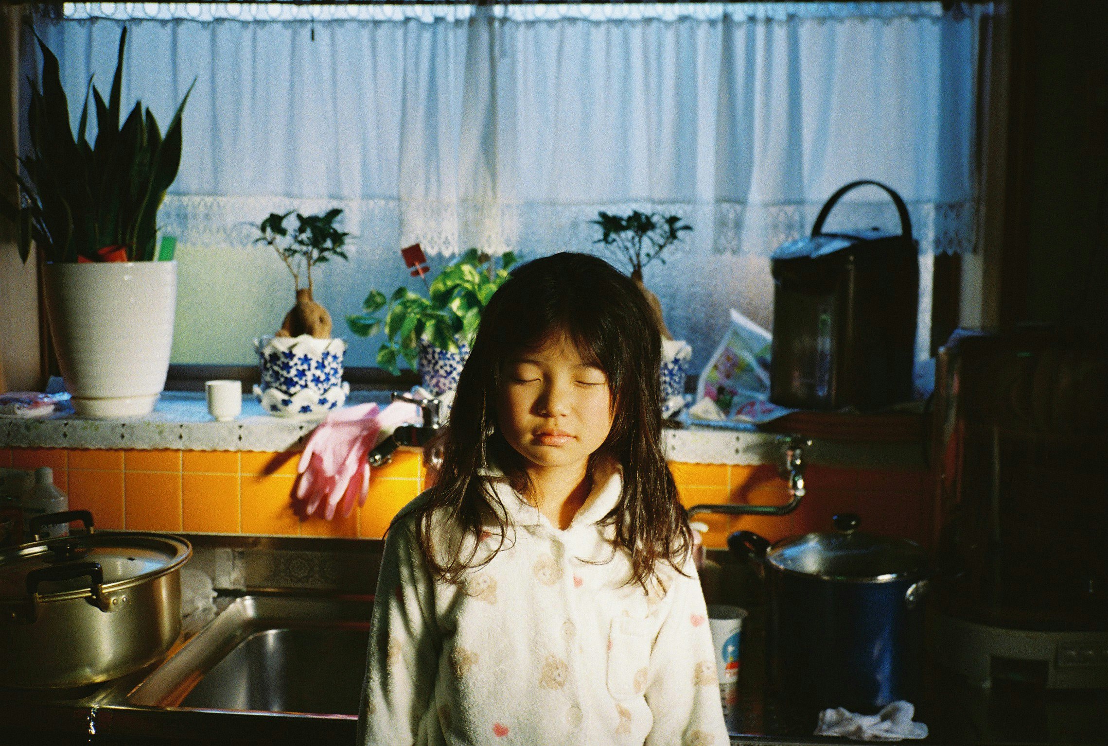 child standing in a kitchen