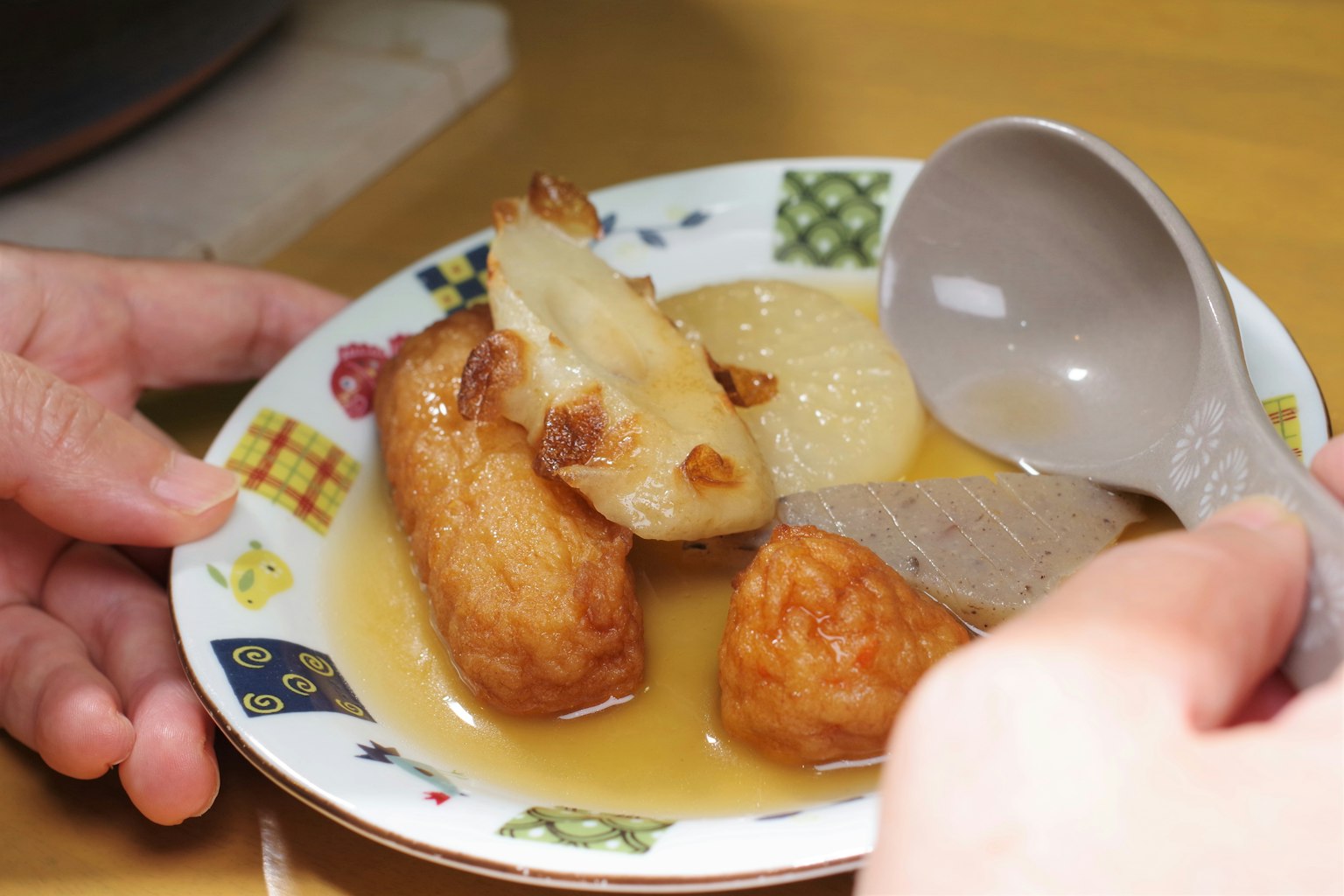 Piring makanan rebus dengan sendok di tangan