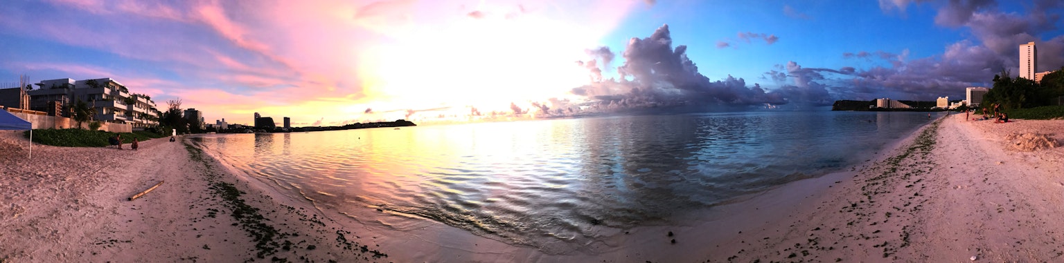 Beautiful beach panorama with sunset and calm waters