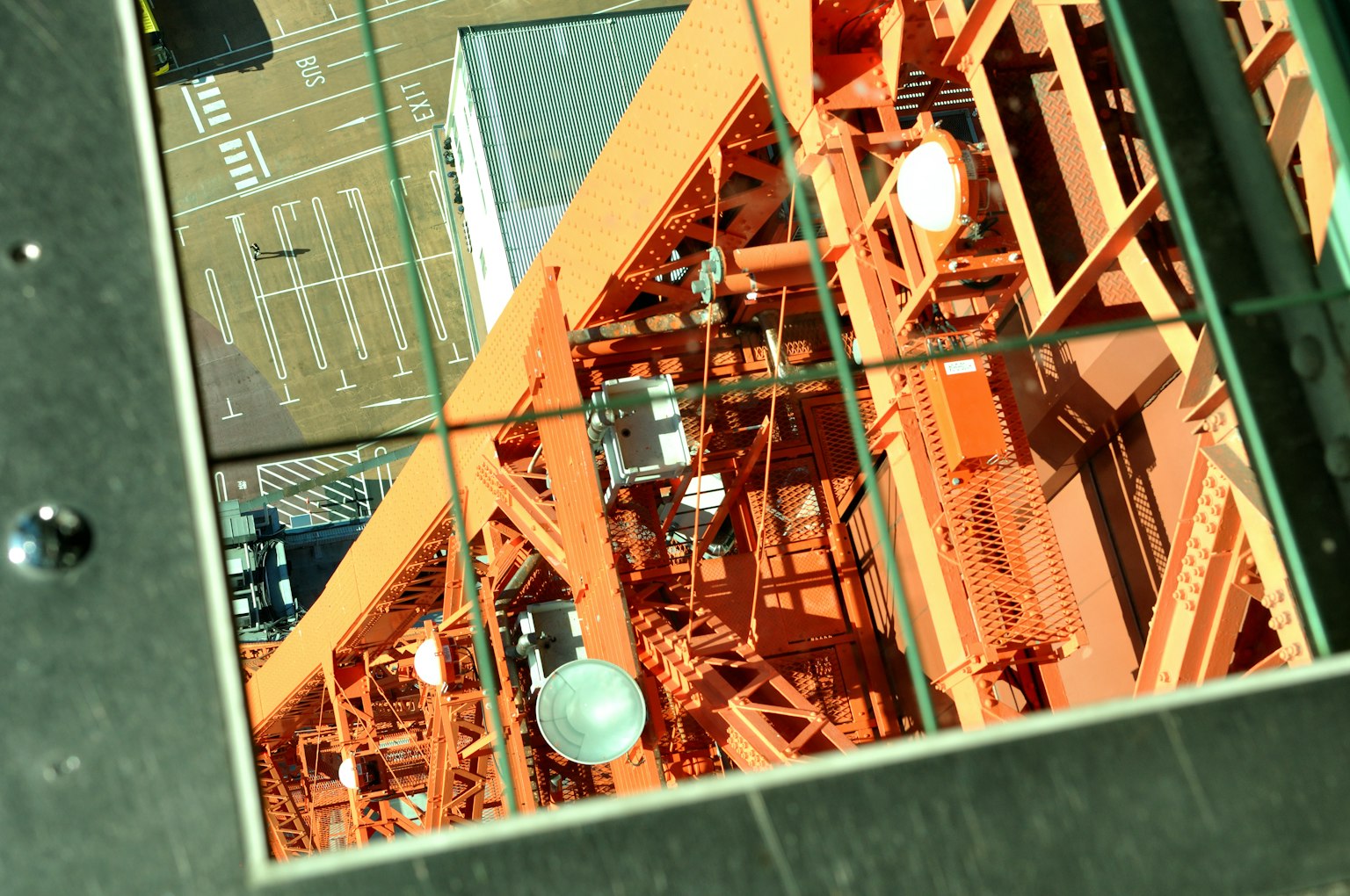 Industrial view featuring an orange structure and glass reflections