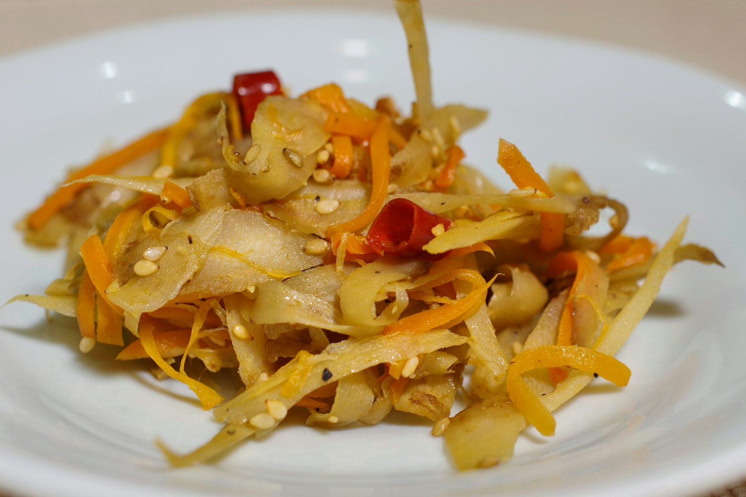 Colorful vegetable salad served on a white plate