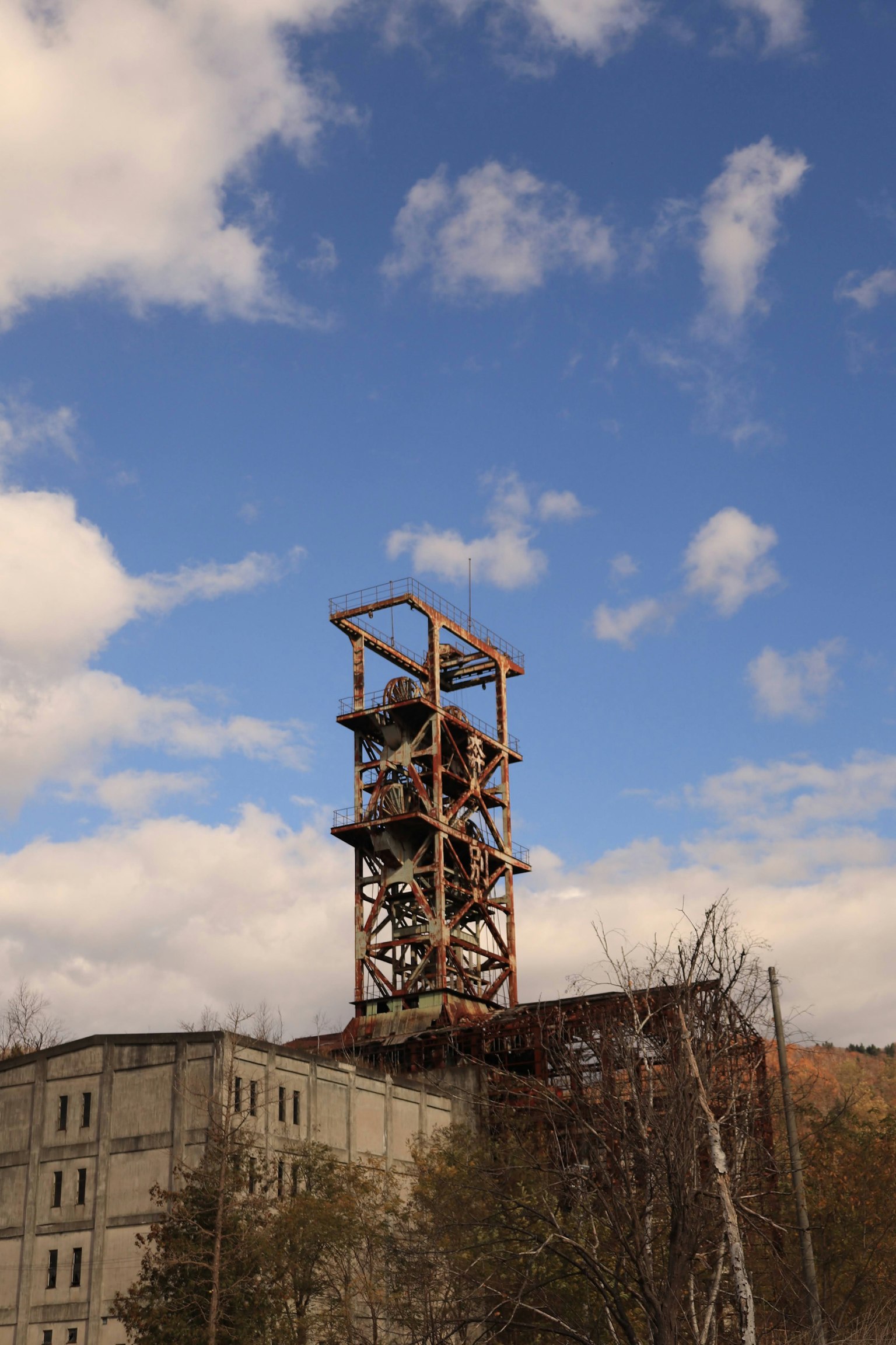 Old mining tower and building under a blue sky