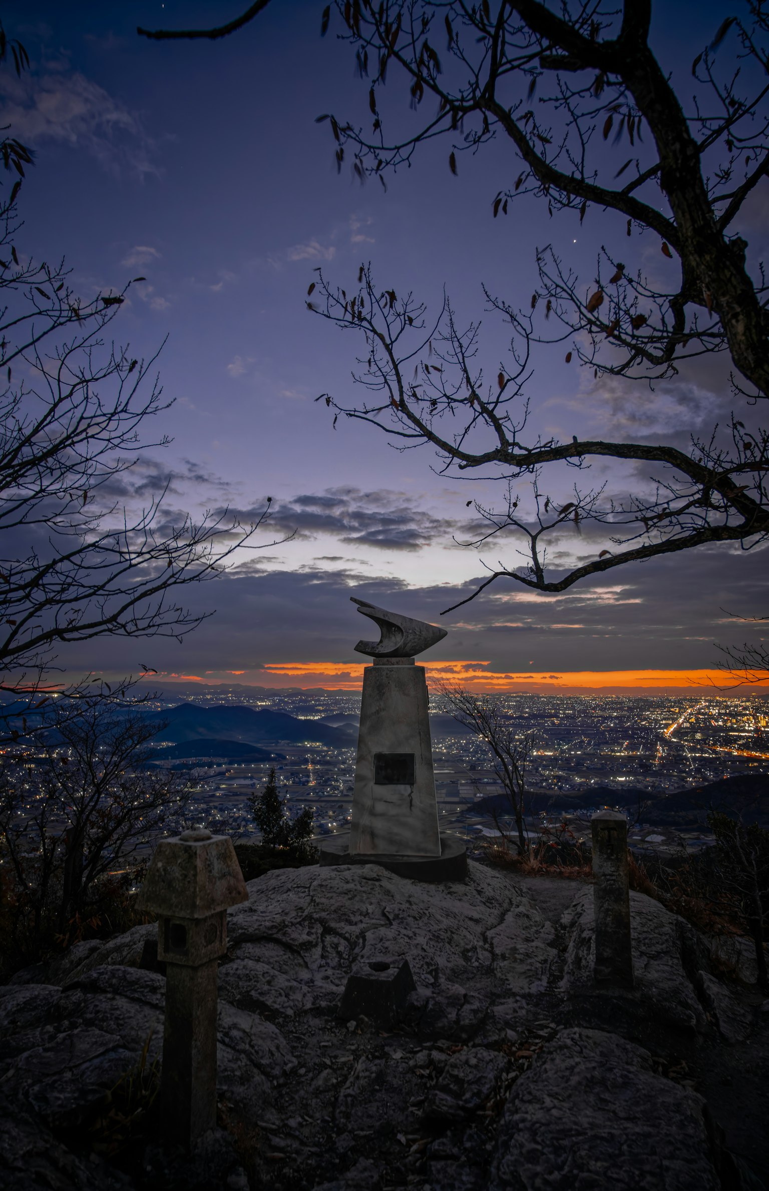 Mountain top monument with sunset sky and surrounding landscape