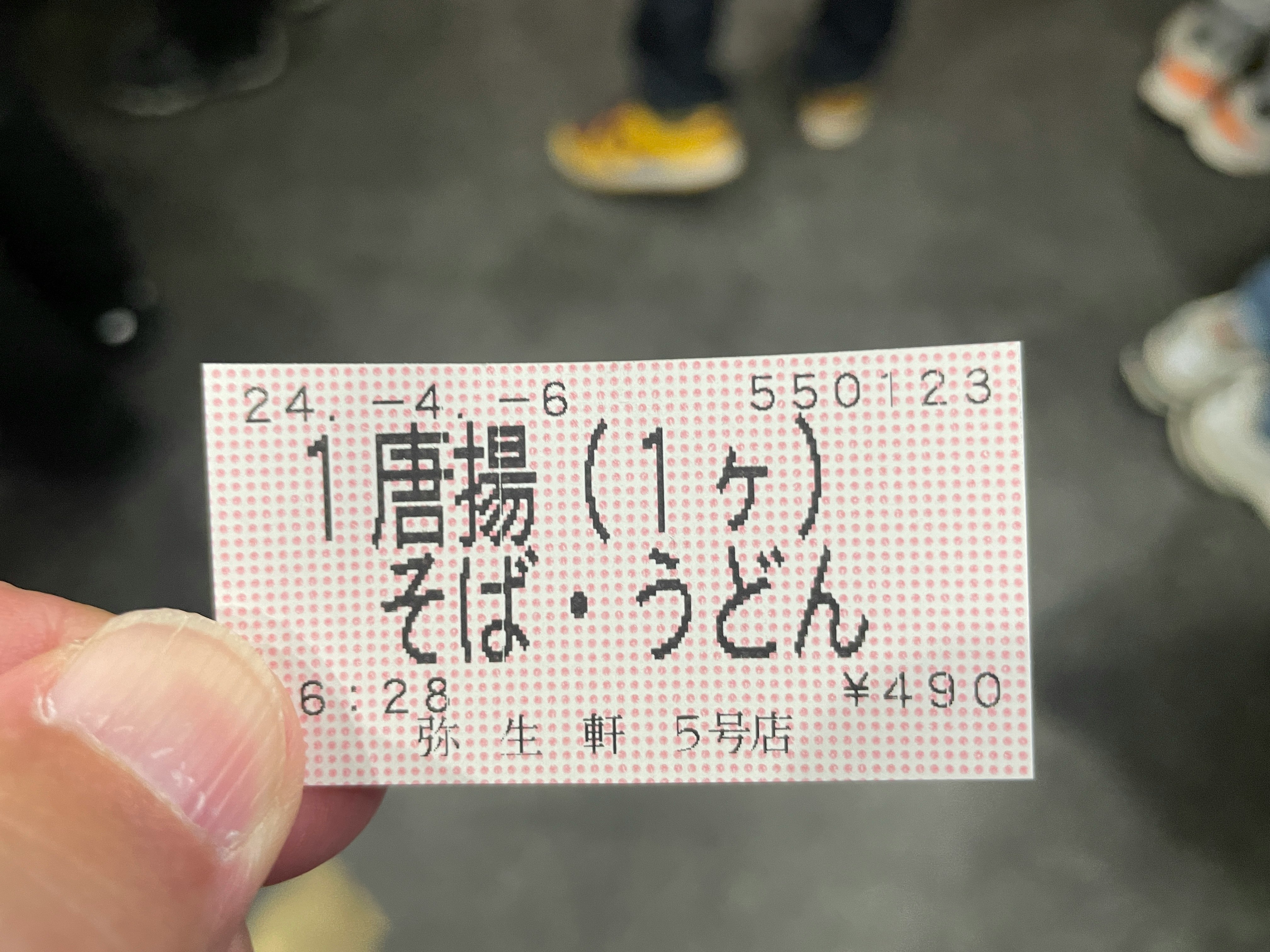 handheld ticket card marked “karaage (1 piece)”