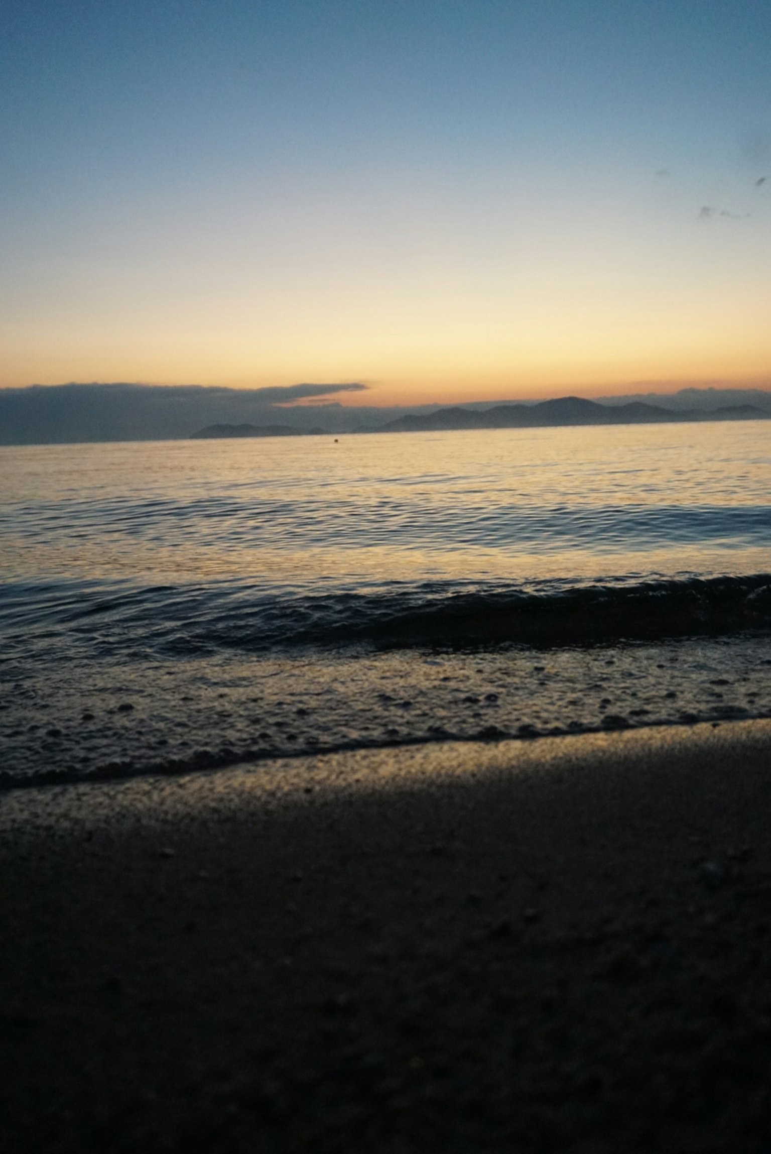 Spiaggia serena al tramonto con onde leggere