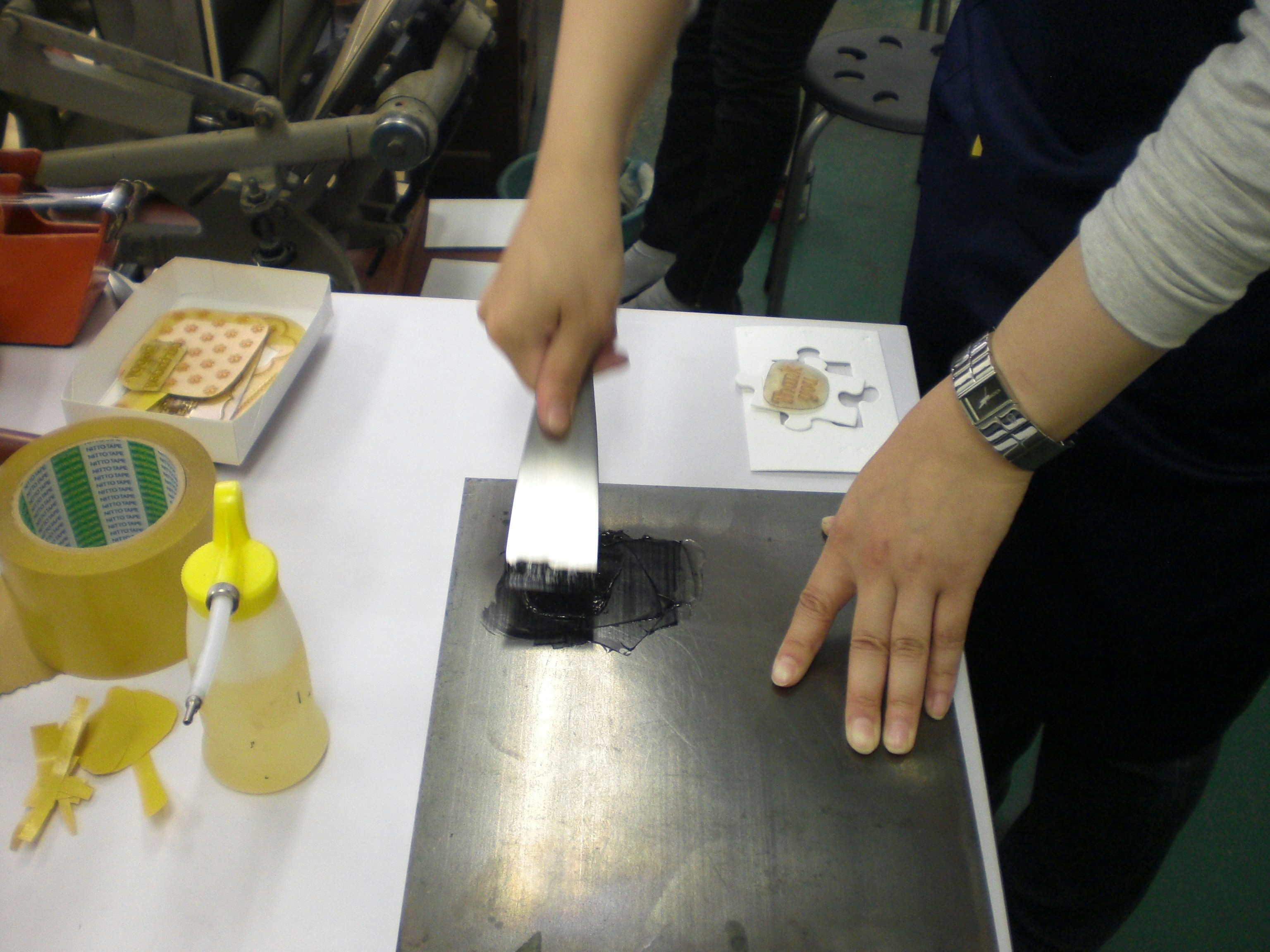 hands assembling a craft kit on a table