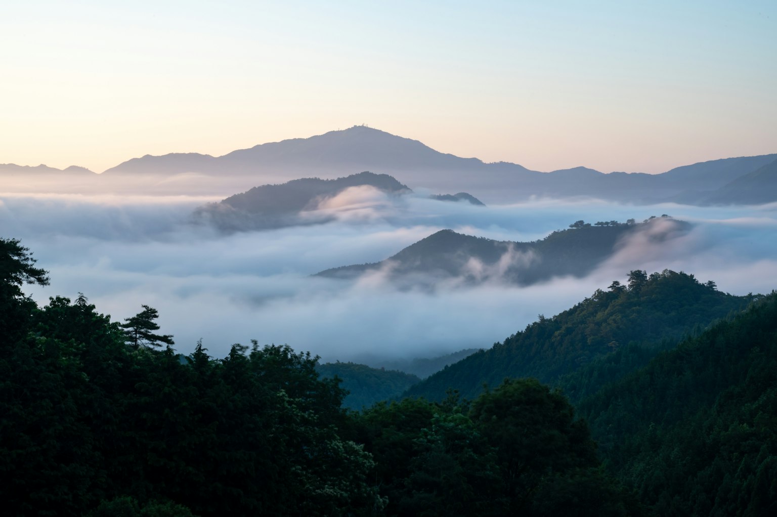 Malersiche Aussicht auf von Nebel umhüllte Berge mit sanftem Morgenlicht