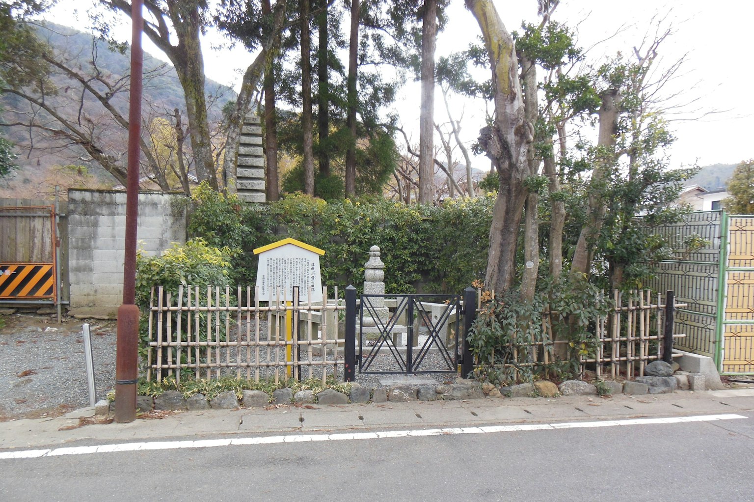 Pemandangan taman tenang dengan monumen batu dan patung kecil