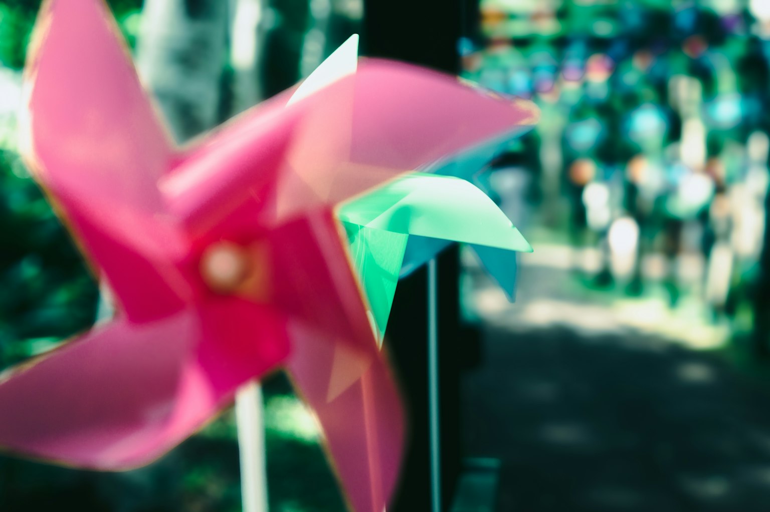 Colorido molino de viento en primer plano con personas borrosas de fondo