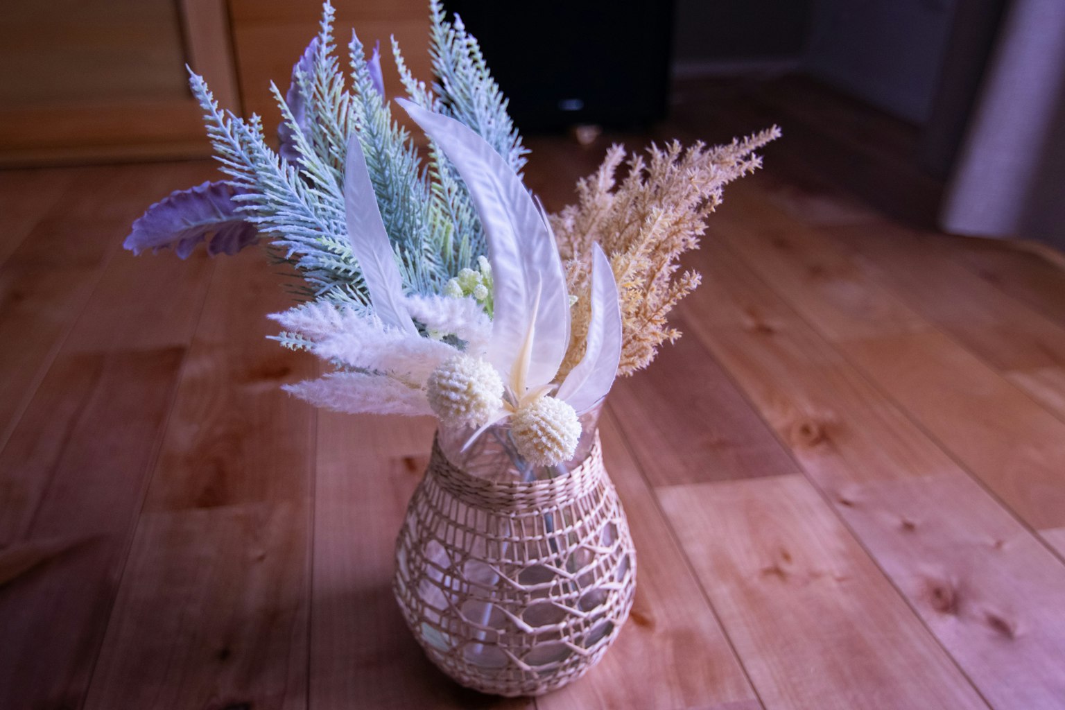 Delicate dried flowers arranged in a handwoven basket