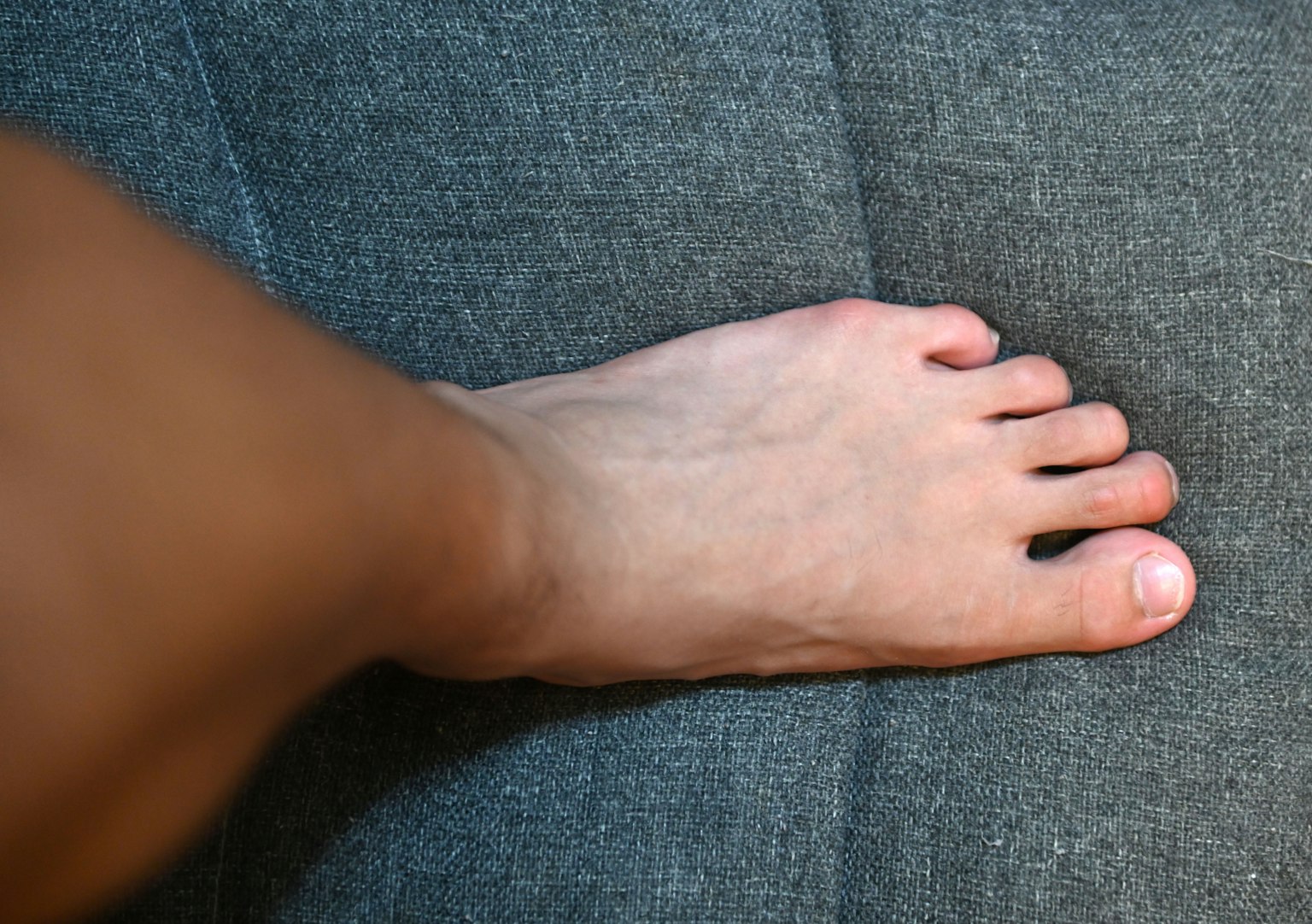 Human foot resting on blue fabric