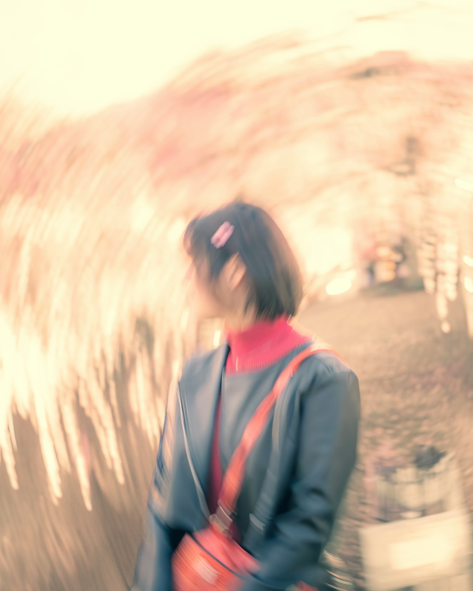 A blurred background with a woman wearing a red sweater turning her head