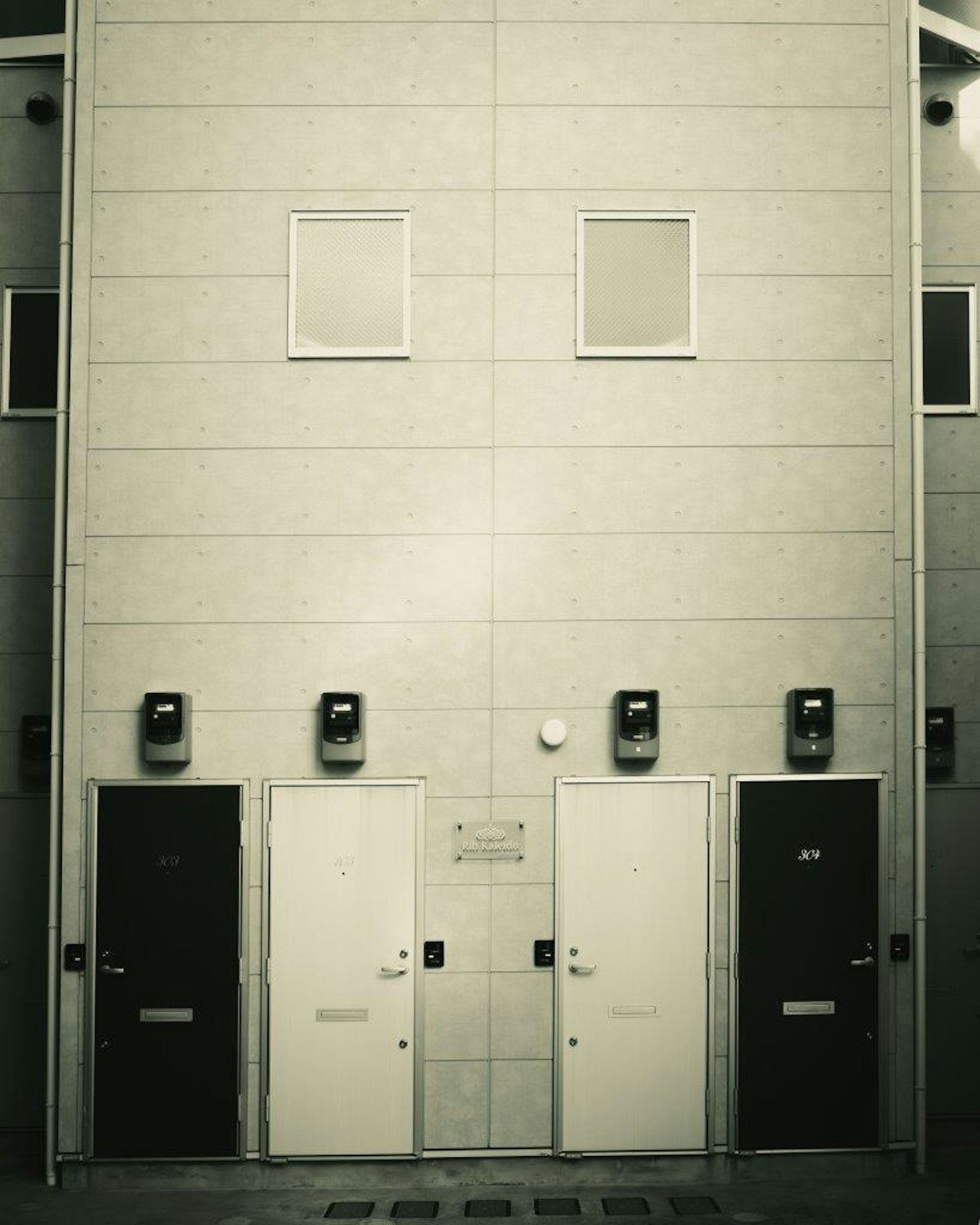 Modern building facade with black and white doors