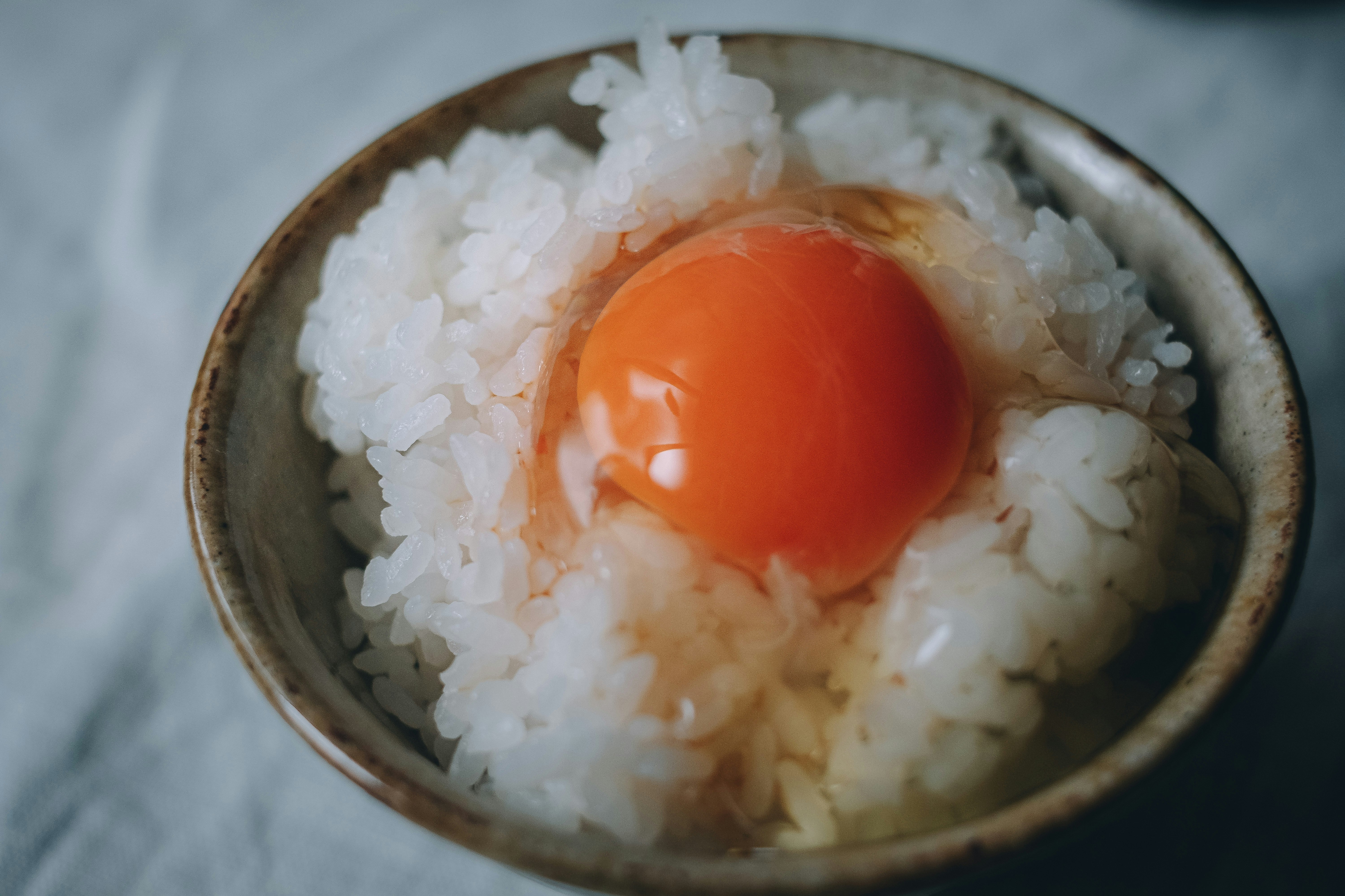 bowl of white rice with a runny soft-boiled egg