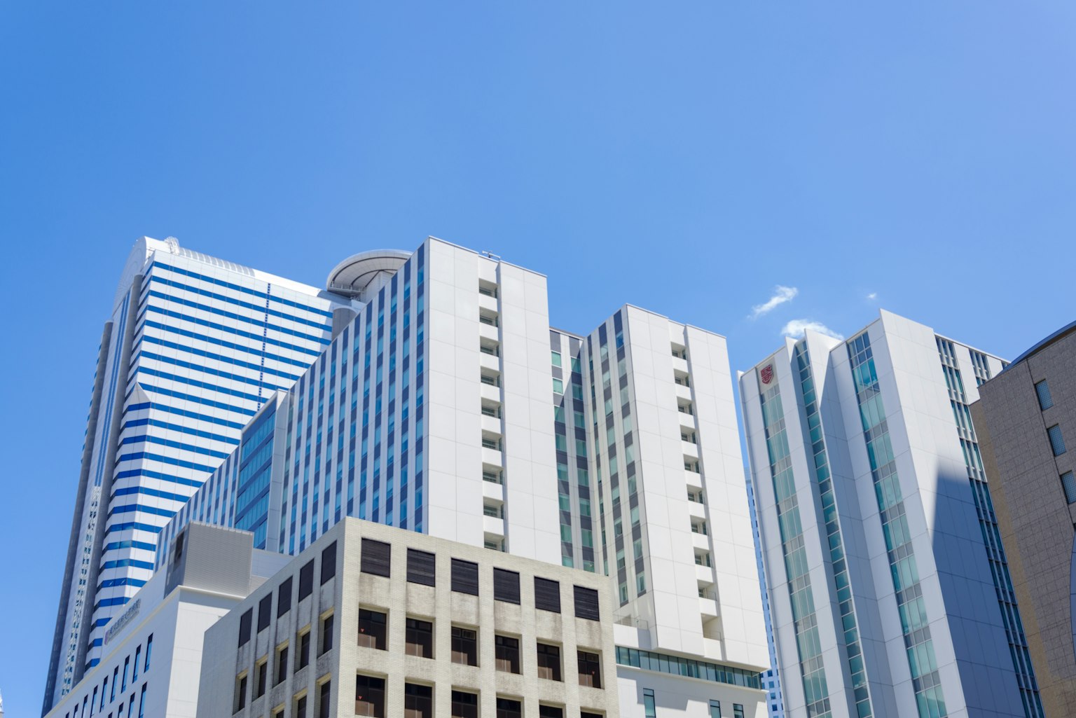 Photo of high-rise buildings towering under a clear blue sky