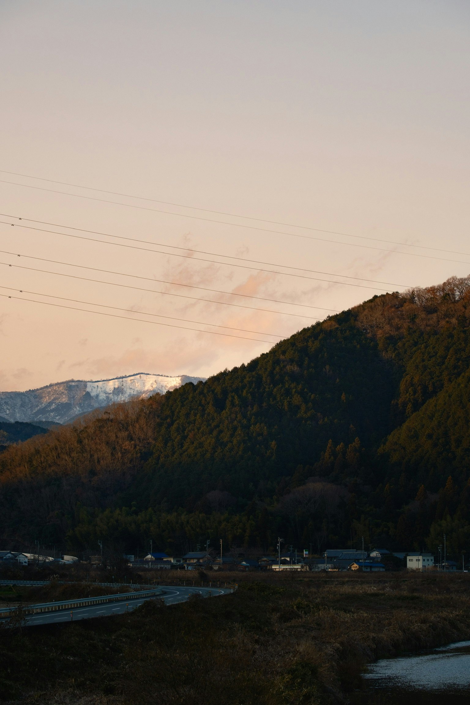 mountain range and riverside village at dusk