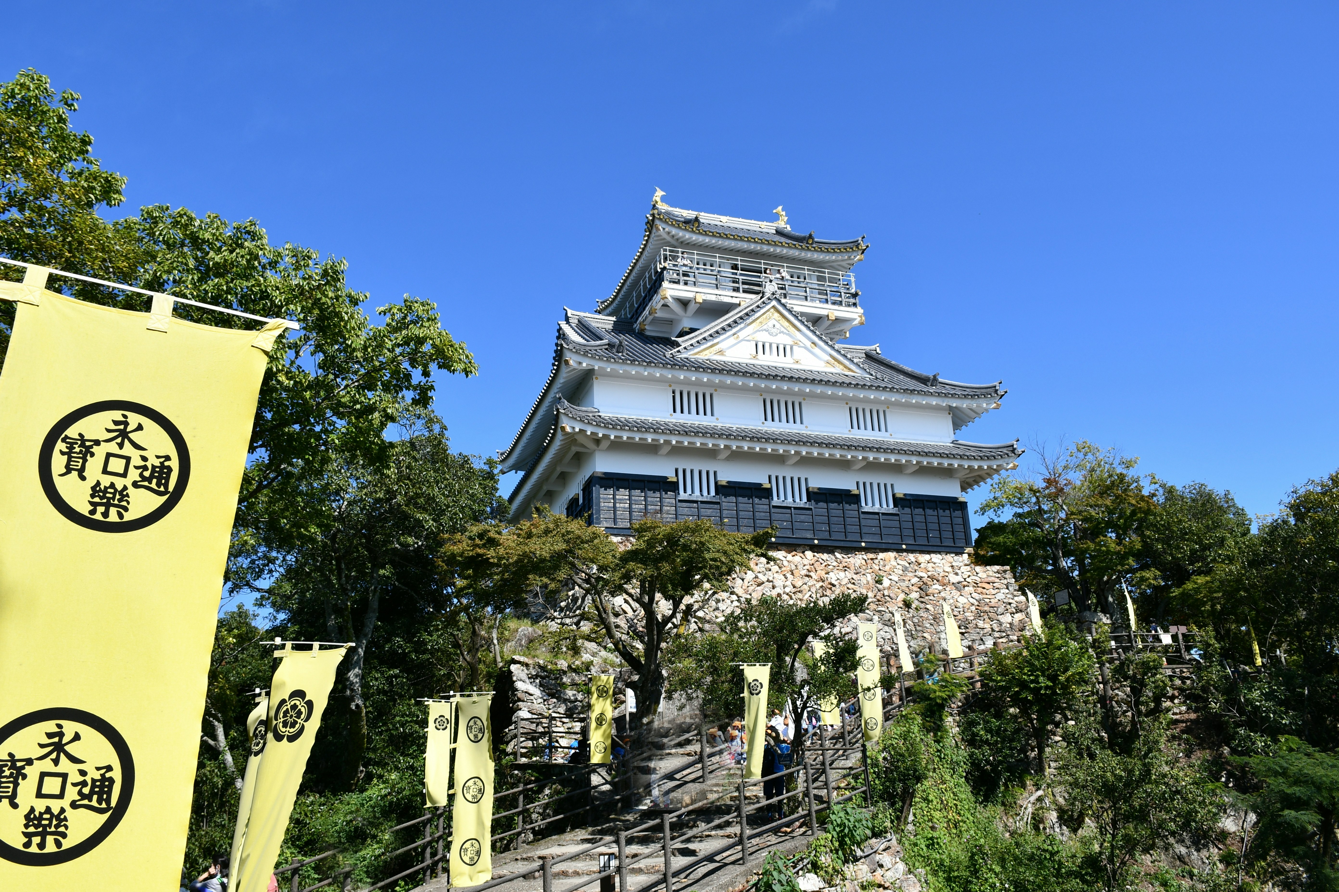 castle keep under a clear blue sky with tourism banners