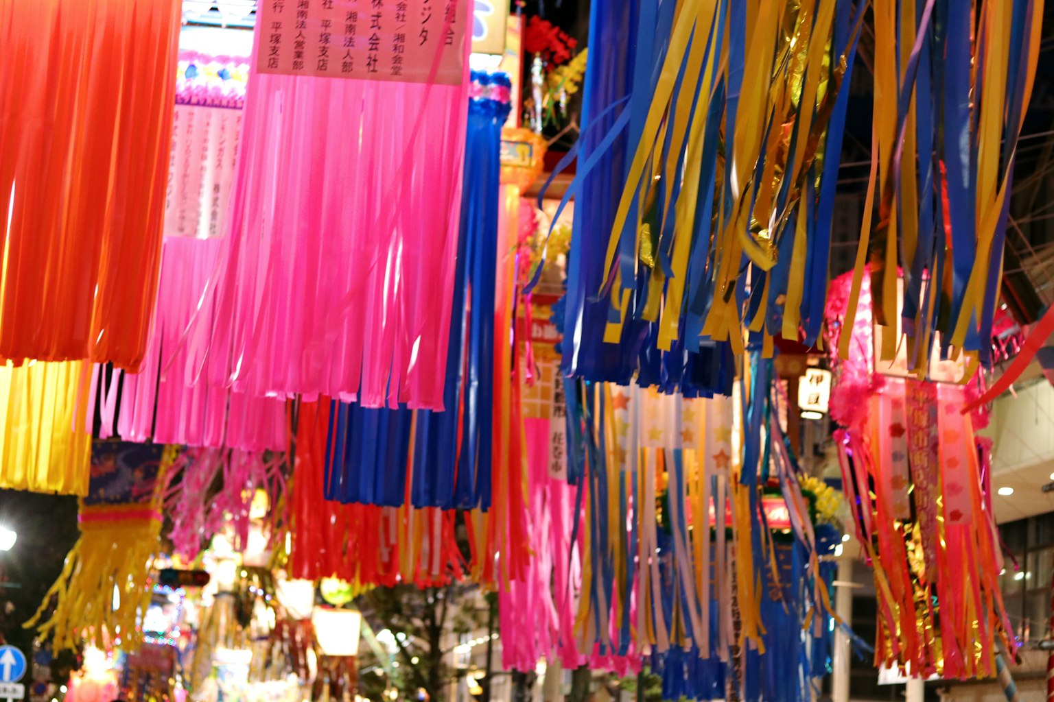 Colorful ribbons hanging in a night street scene