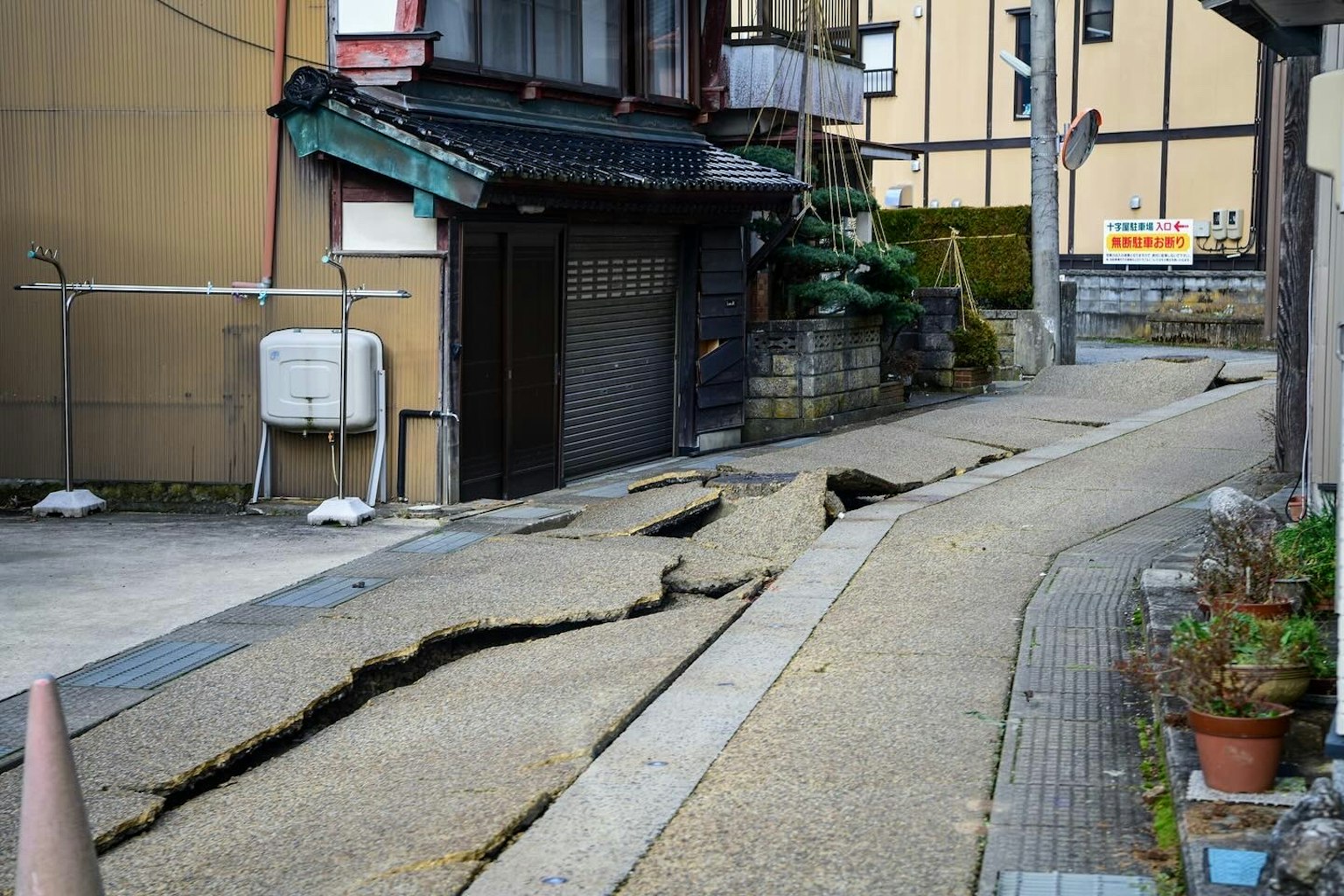 Cracked road due to earthquake with surrounding buildings