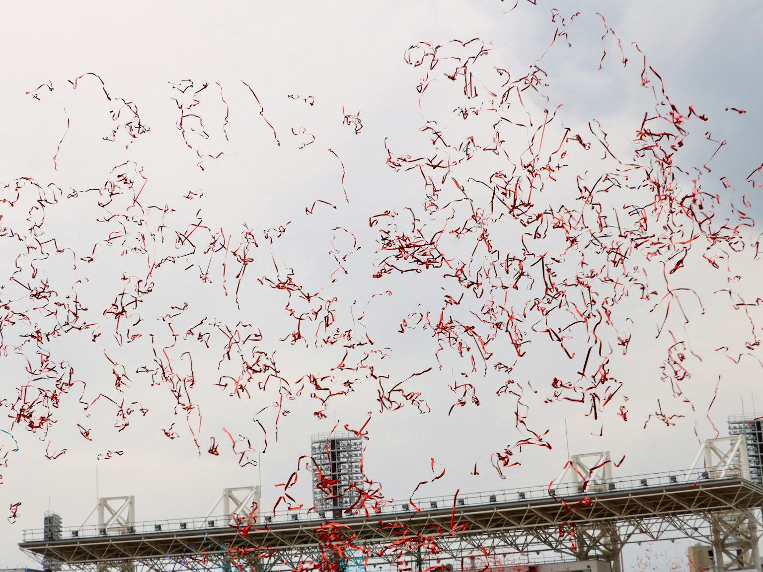 A multitude of red balloons floating in the sky