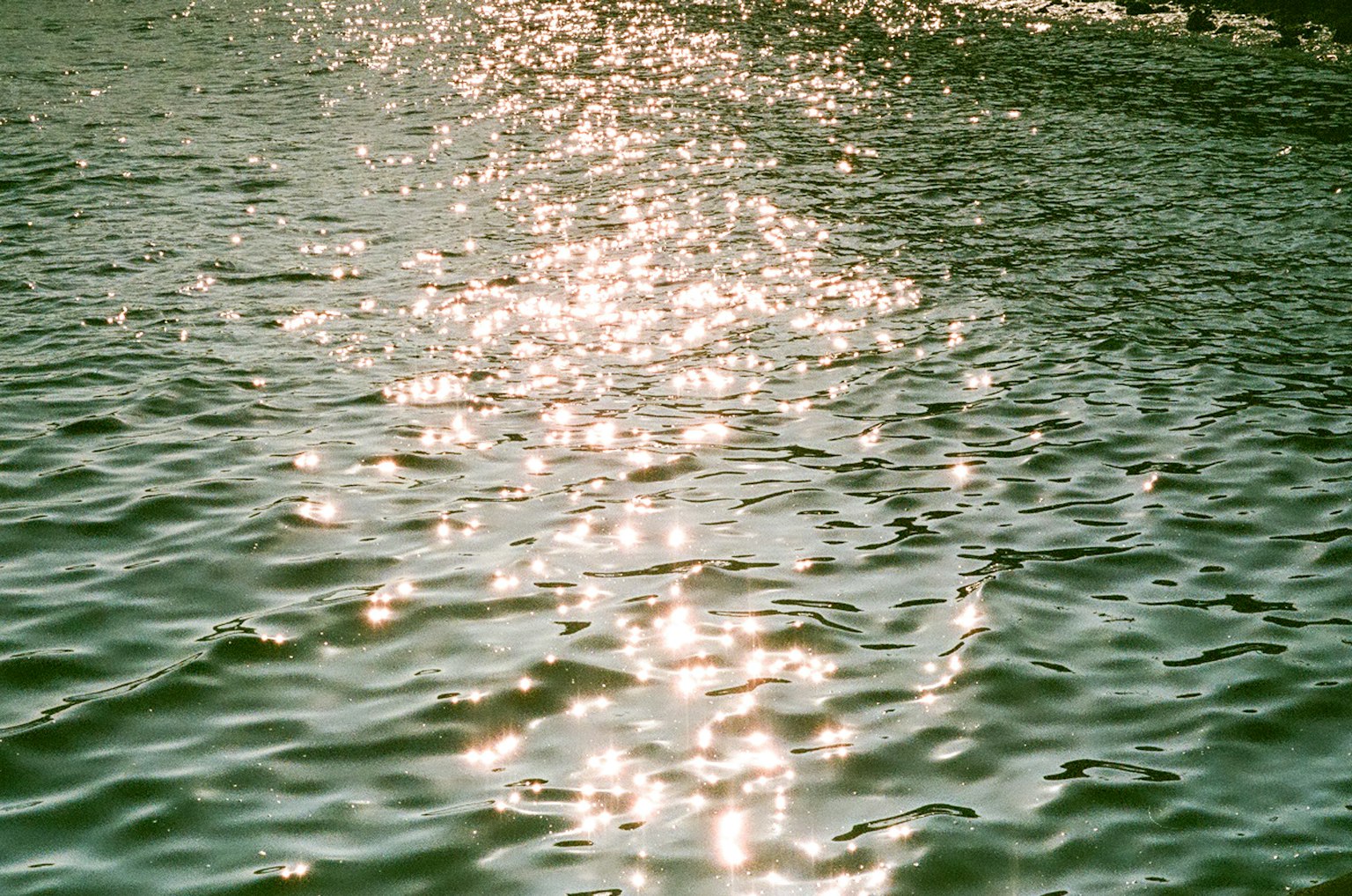 Beautiful green water with reflections of light on the surface
