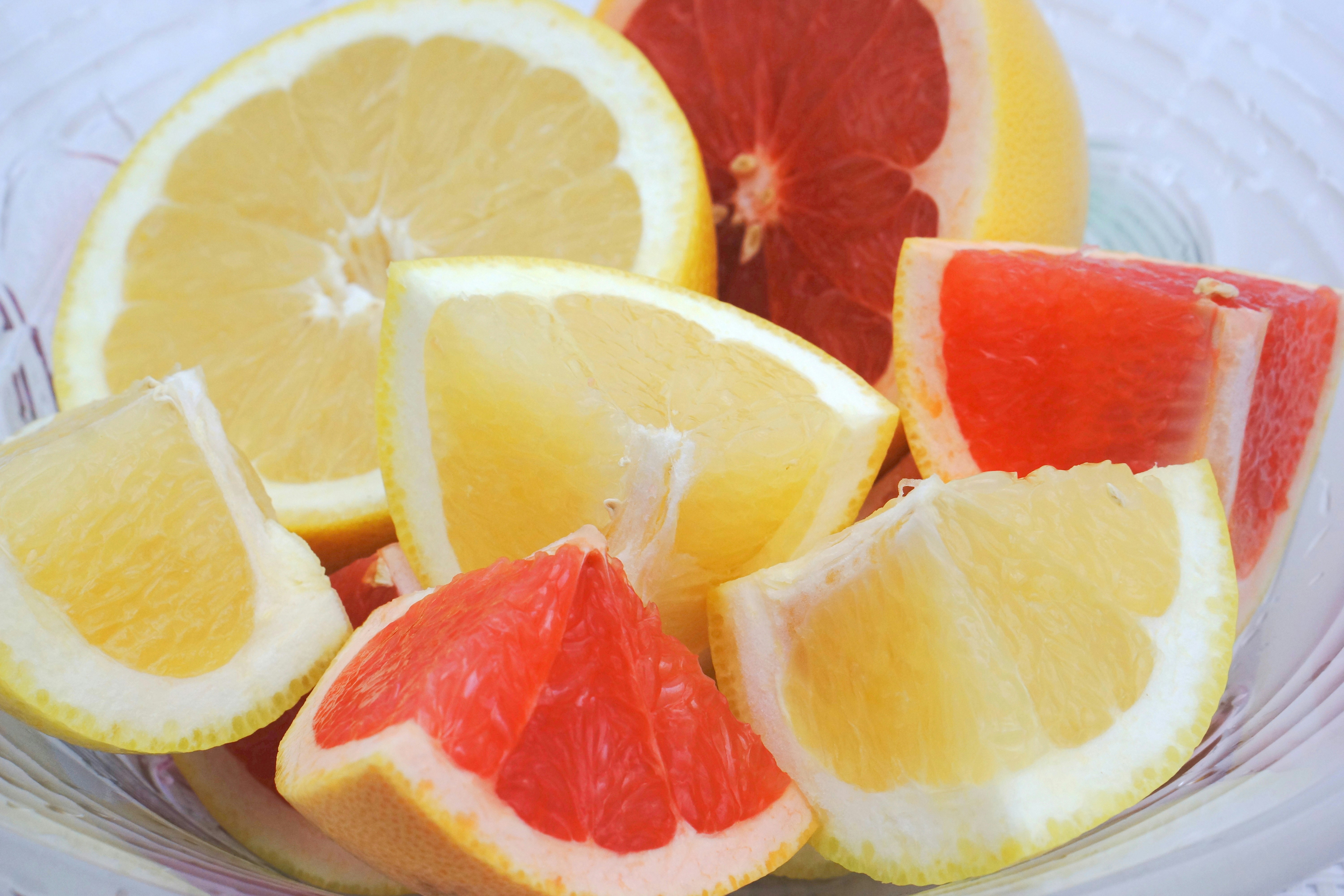 Close-up of sliced lemon and grapefruit segments on a plate