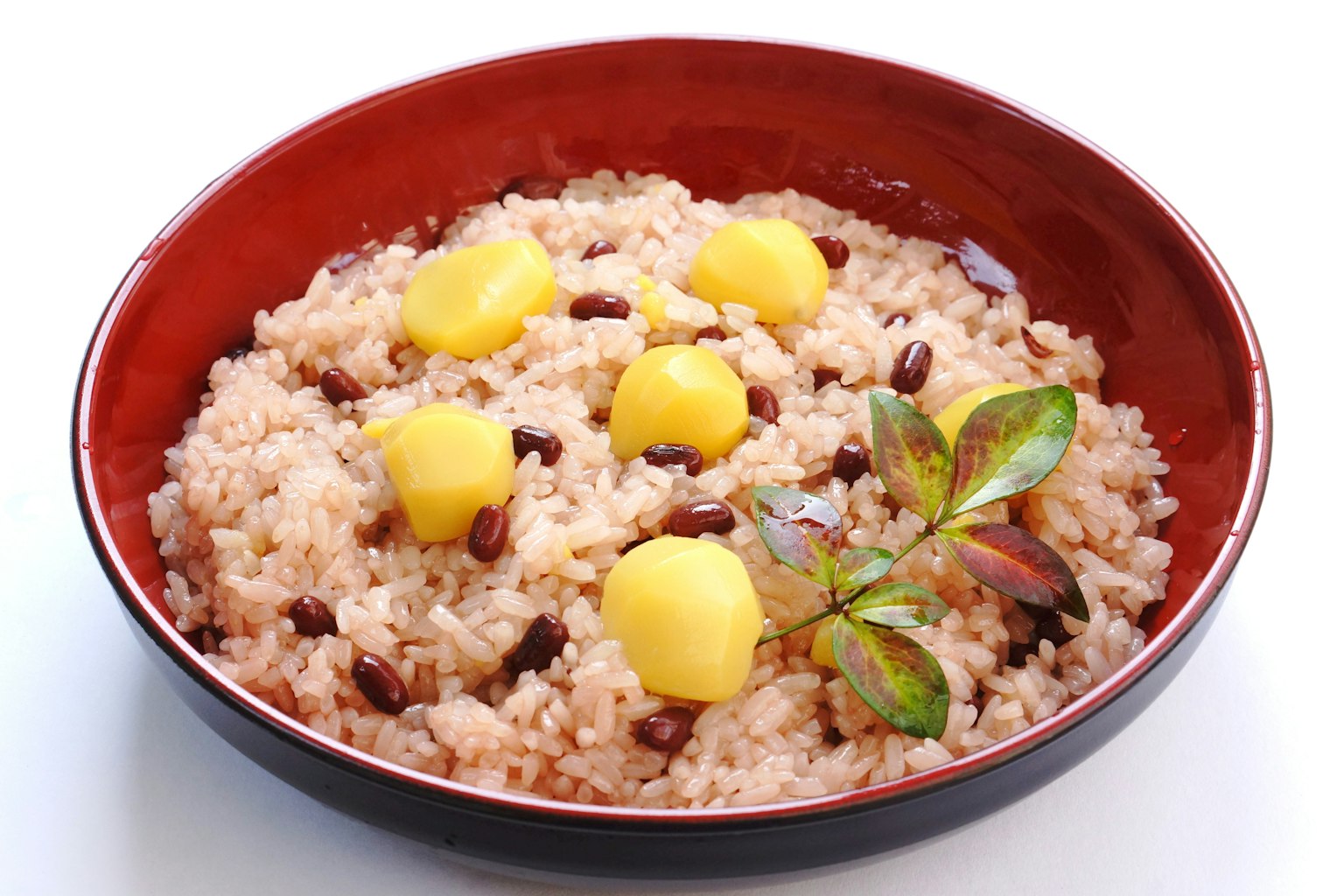 Dish of glutinous rice with yellow chestnuts in a red bowl